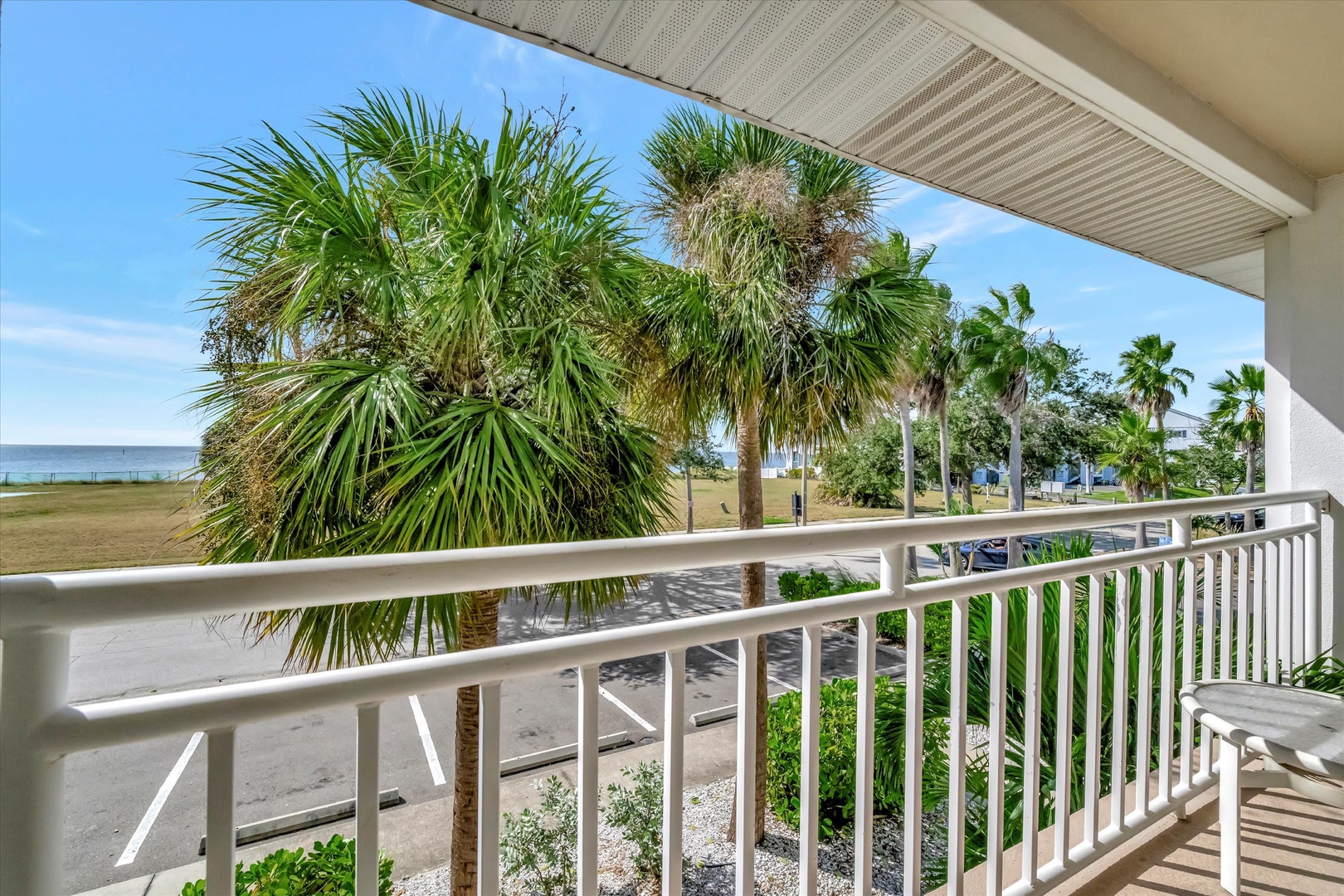 Soak up the coastal breeze from your private balcony with stunning views of swaying palms and sandy shores just steps away—your perfect escape to paradise.