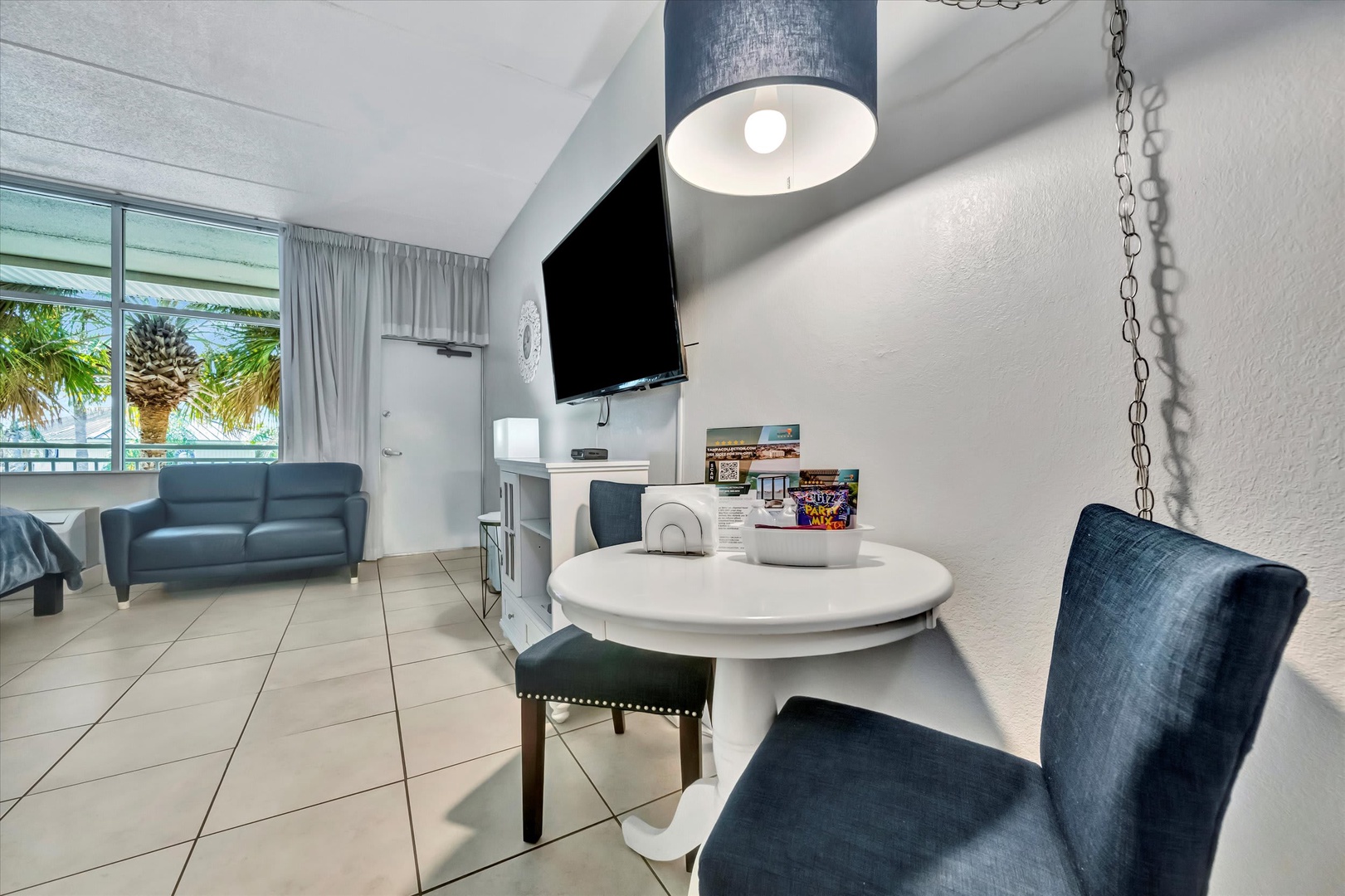 Settle into your bright, coastal-inspired retreat with cheerful natural light and tropical palms just outside your window.