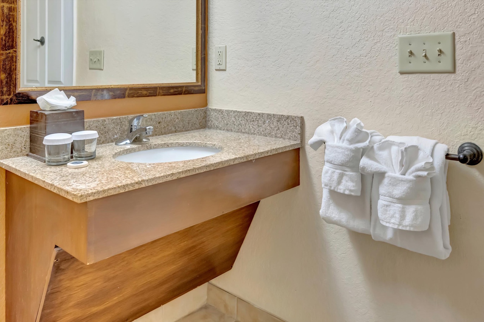 Your private bathroom features a granite vanity, fresh linens, and thoughtful touches for a comfortable stay.