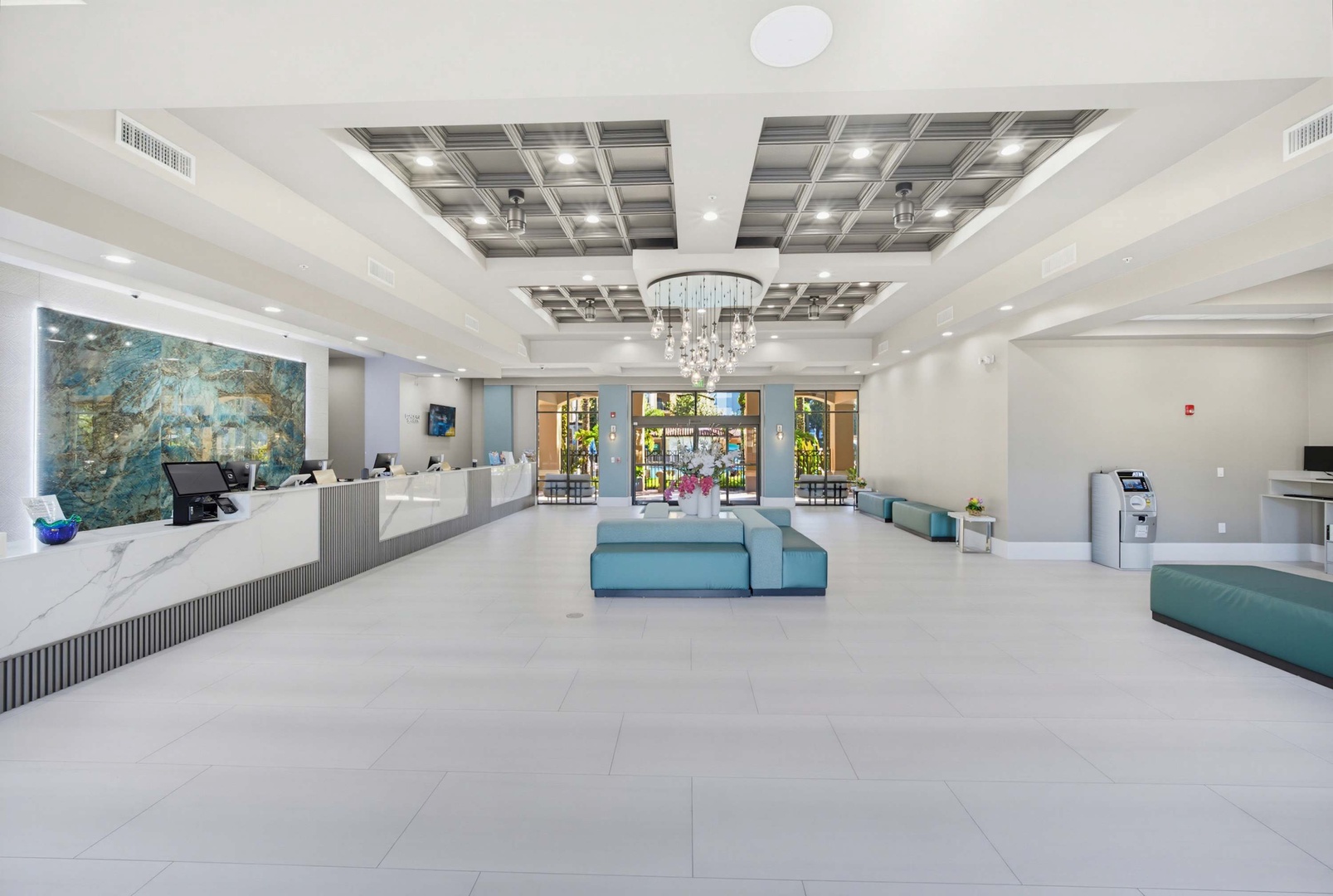A bright, modern lobby welcomes guests with elegant marble accents, contemporary furnishings, and natural light streaming through the entrance—your arrival sets the tone for a stylish stay.