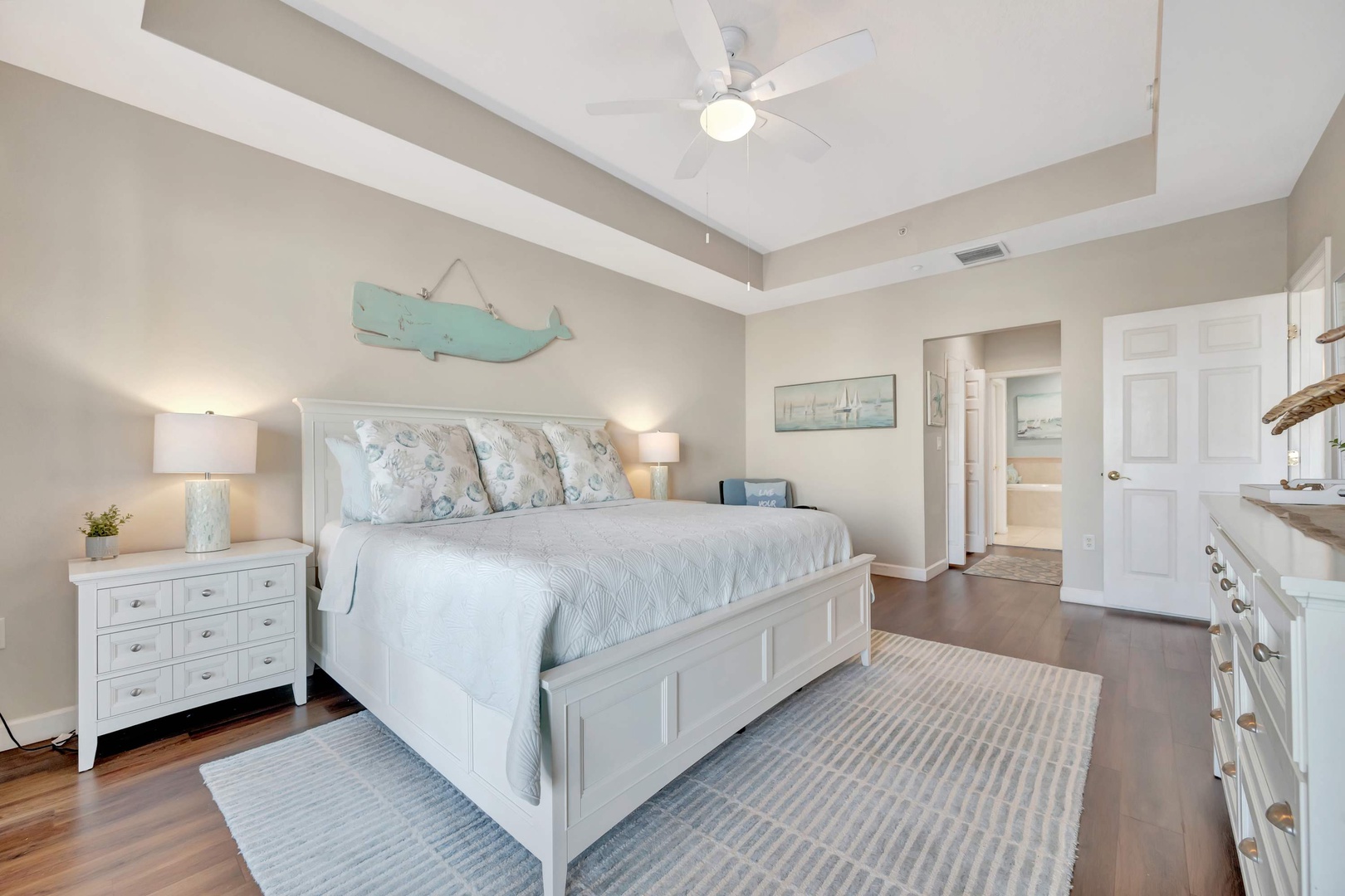 Rest easy in your coastal retreat with vaulted ceilings, soft ocean-inspired tones, and an en-suite bath just steps away. Your serene escape awaits.