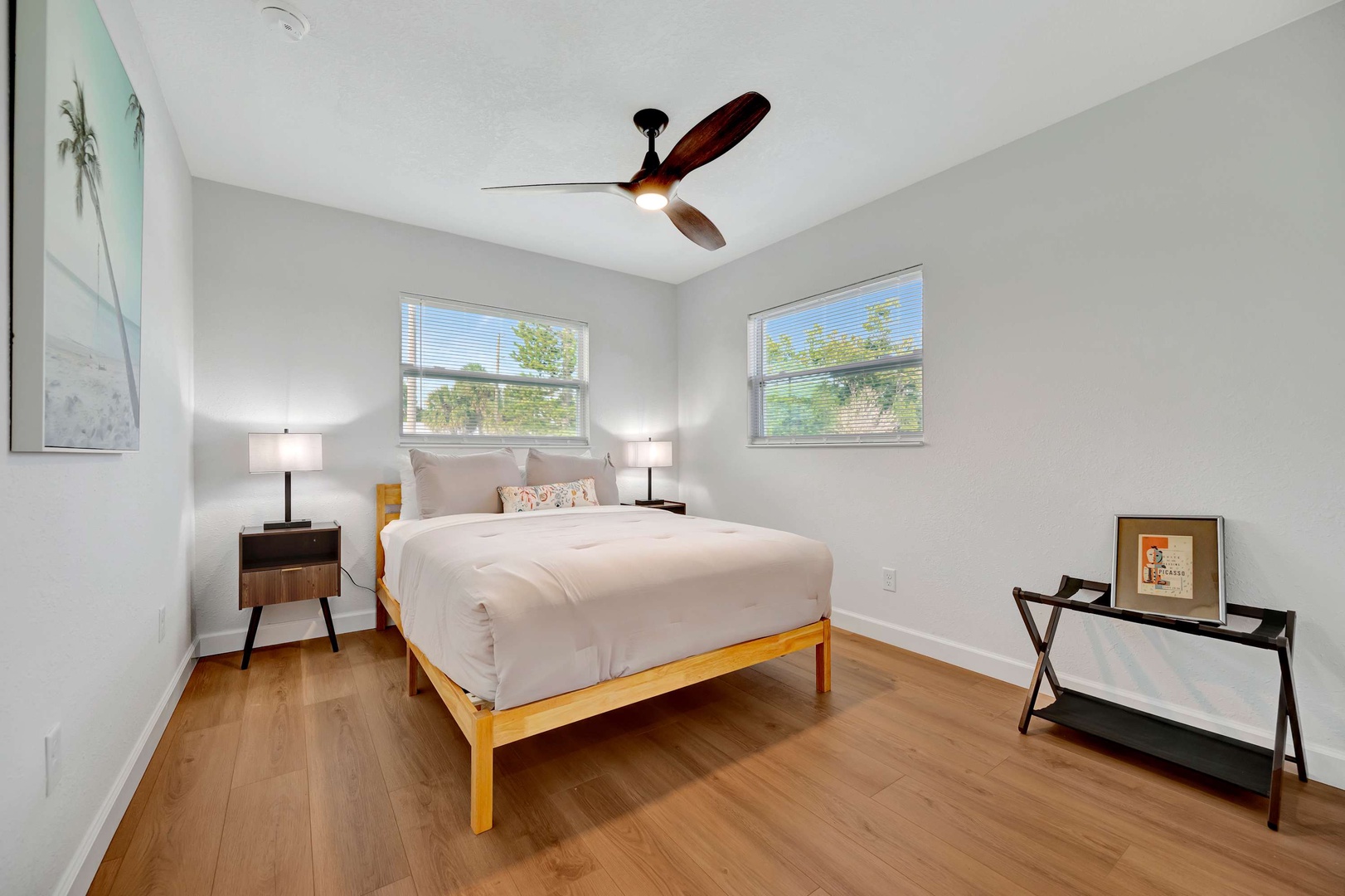 Slip into crisp linens and feel the breeze from your private ceiling fan—this bright, peaceful bedroom invites you to unwind in total comfort.