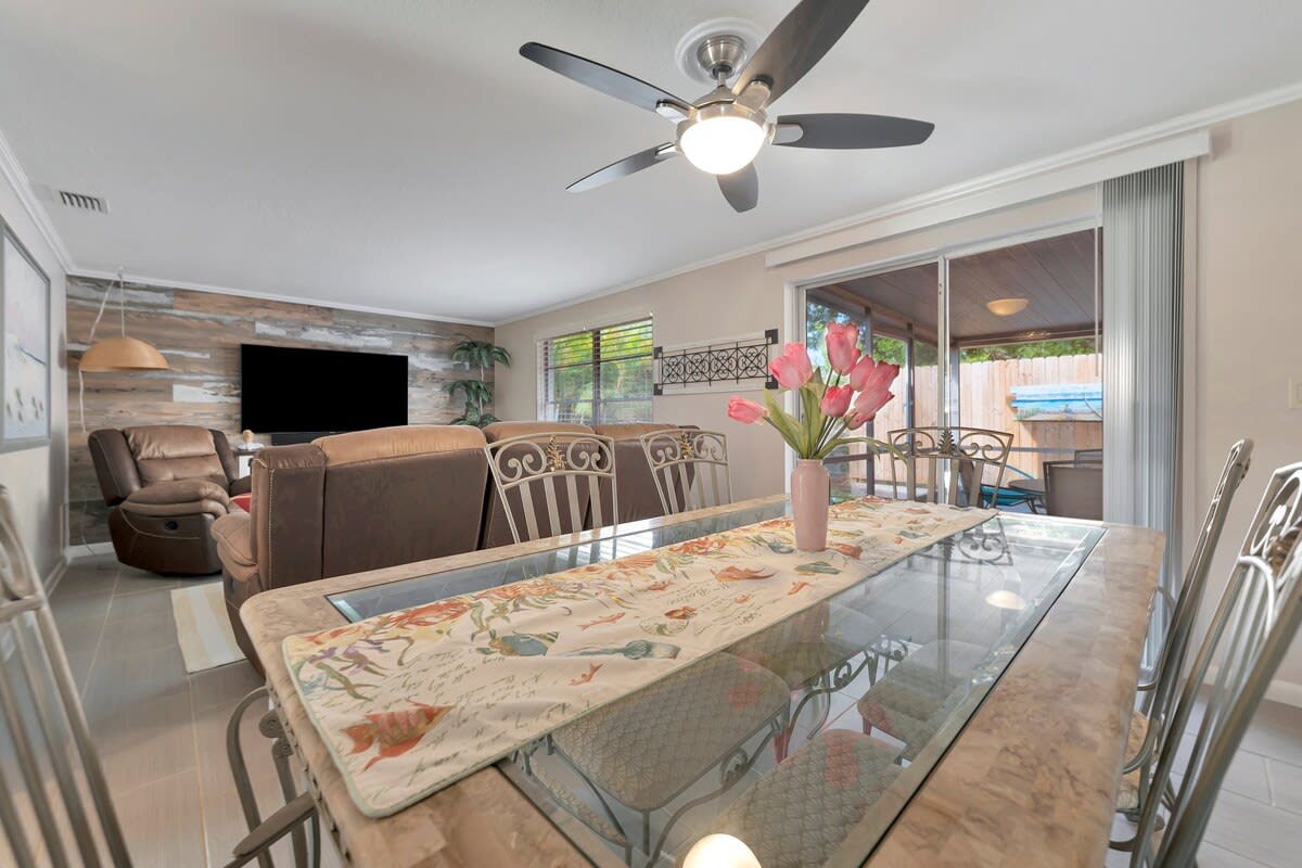Gather around your elegant glass dining table, where fresh flowers brighten every meal and the open layout flows seamlessly into your cozy living space with plush seating.