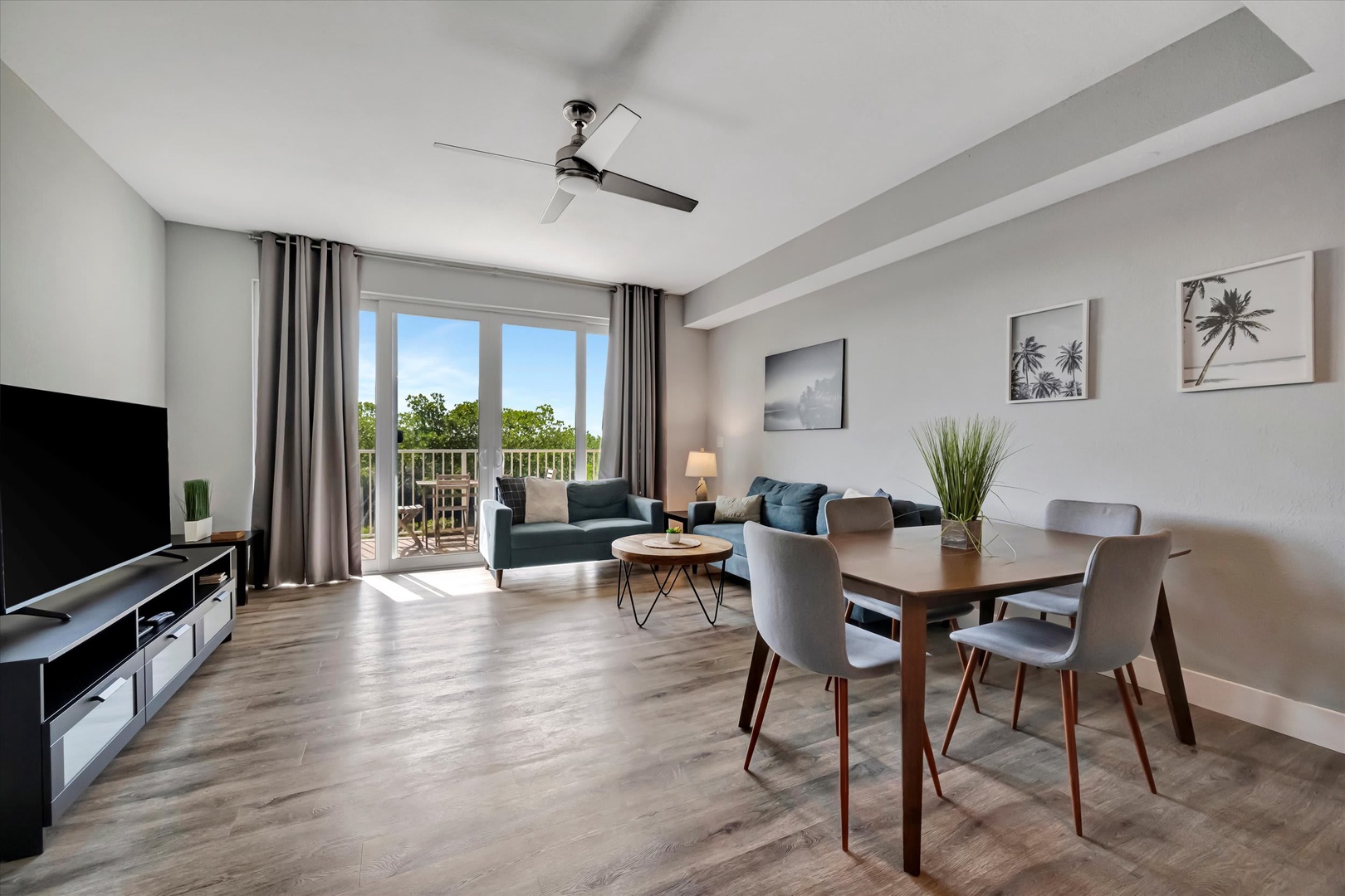 Settle into your open living and dining space where modern comfort meets natural light. Through the glass doors, your private balcony awaits—perfect for morning coffee or evening relaxation.