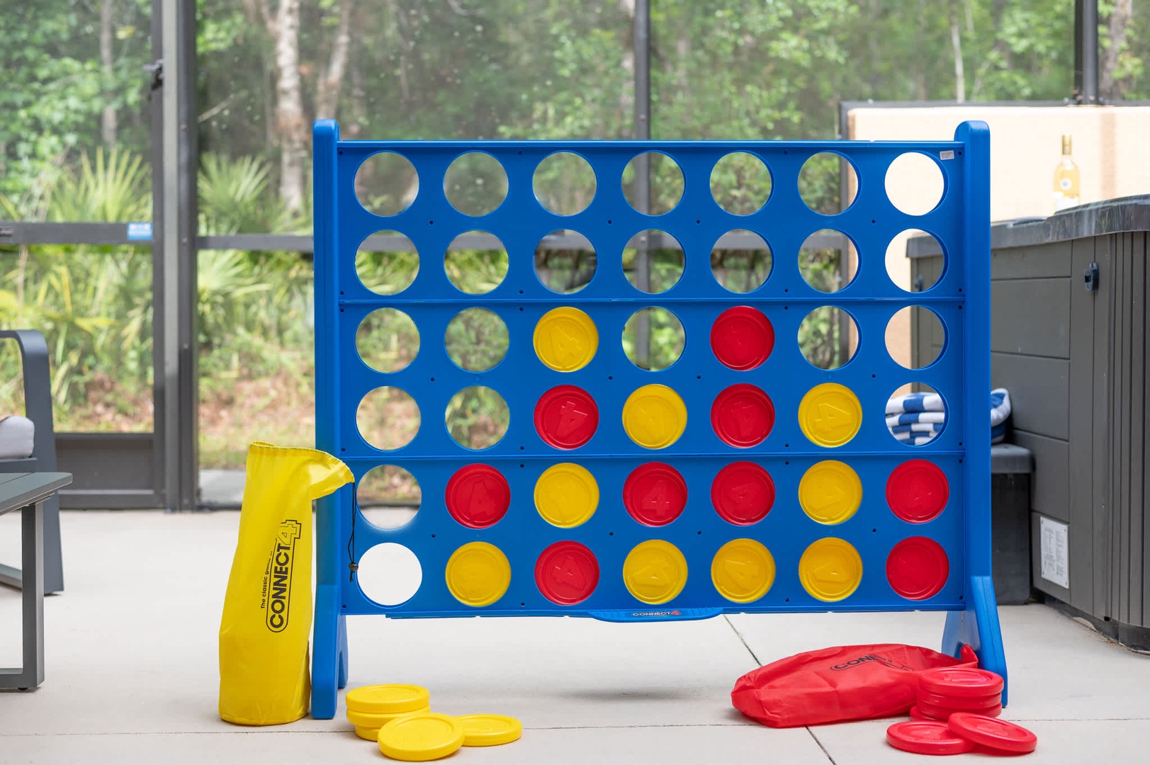 A giant Connect 4 game awaits on your covered patio, ready for friendly competition while you take in views of the surrounding woods through floor-to-ceiling windows.