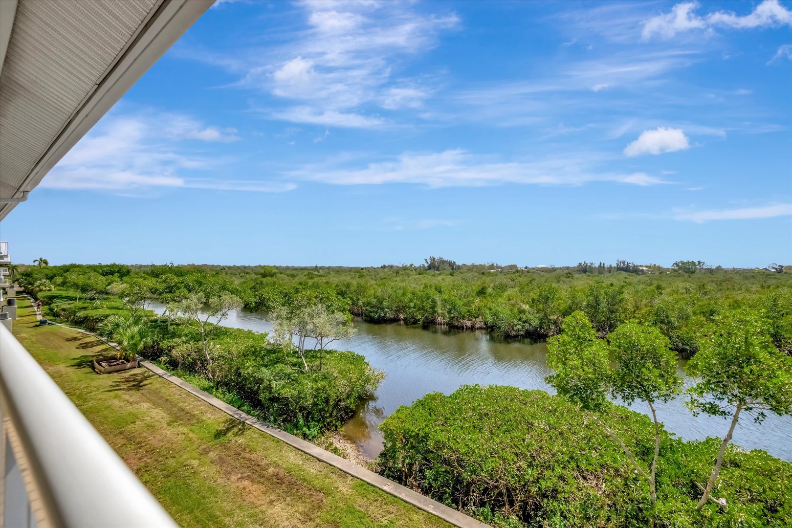 Sweeping views of winding waterways and lush mangrove islands stretch beneath vibrant skies, creating a serene natural backdrop that surrounds the property.