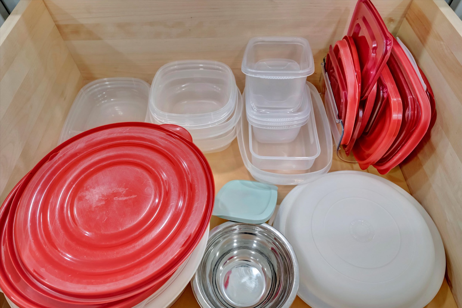 Your kitchen drawer is stocked with everything you need—nested storage containers, mixing bowls, and matching lids keep meal prep organized and easy.