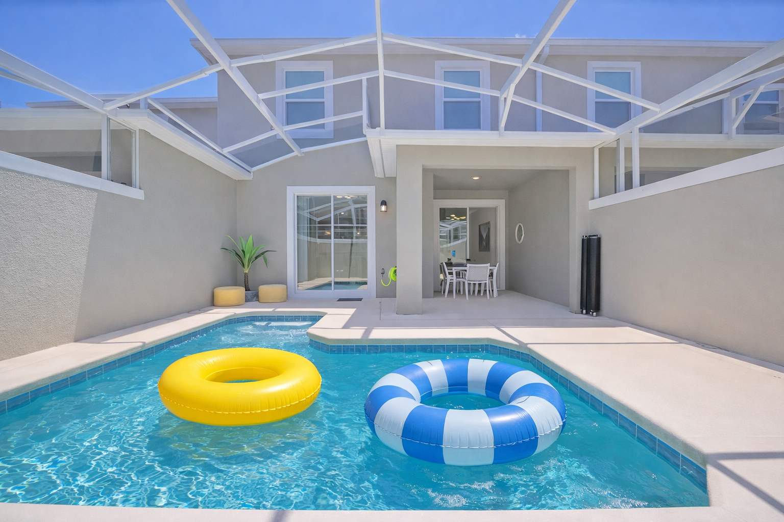 Your private screened pool awaits, complete with colorful floats and a sun-drenched deck—perfect for lazy afternoons and poolside relaxation under Florida sunshine.