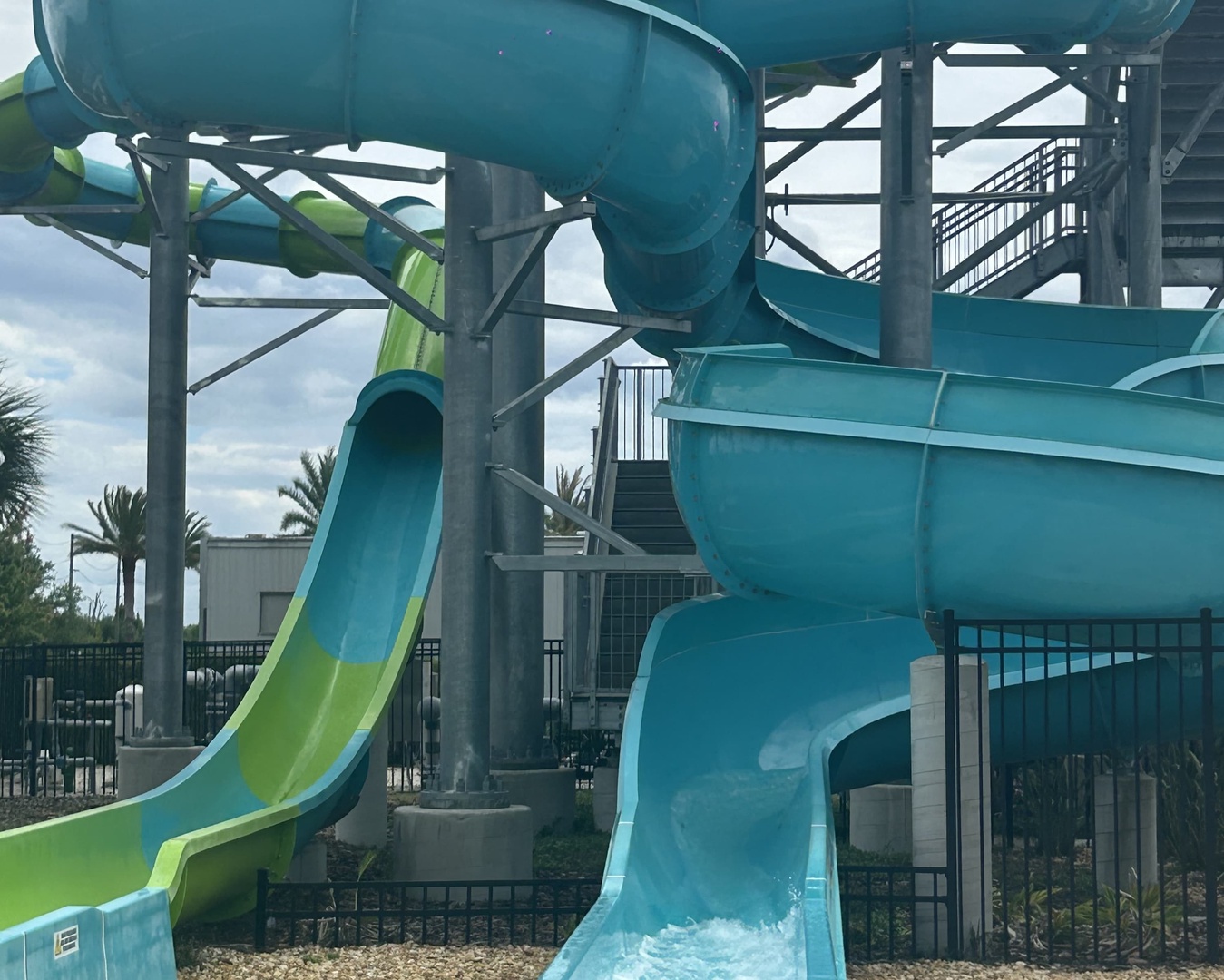 Thrilling water slides tower over the aqua park, ready to send you splashing down twisting turns into refreshing pools below—perfect for sun-soaked fun.