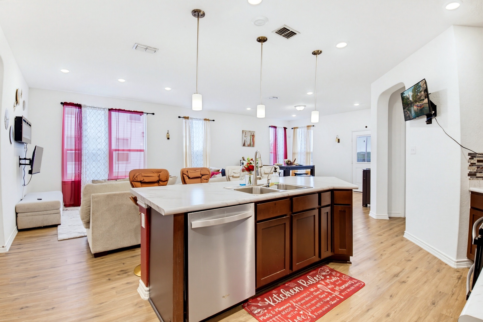 Step into this bright, open-concept living space where your vacation memories begin—a gleaming kitchen island invites you to gather, cook, and connect while sunlight pours through elegant windows.