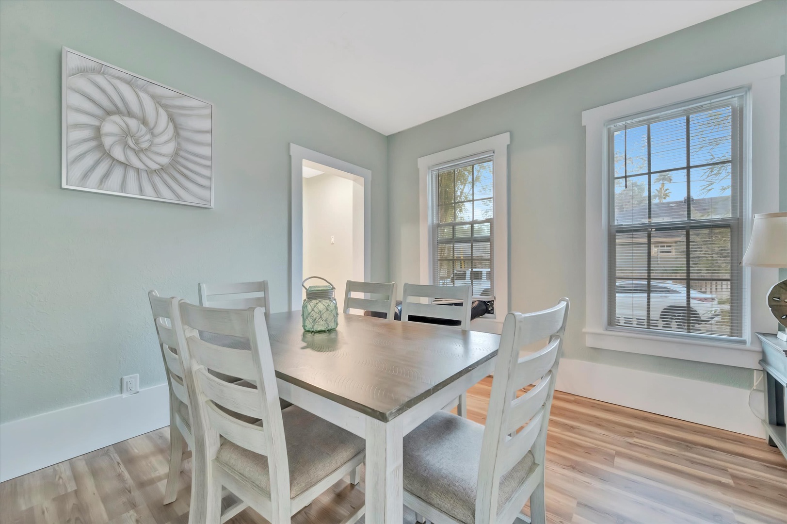 Gather around your spacious dining table where soothing coastal colors and natural light create the perfect setting for morning coffee or evening meals with loved ones.