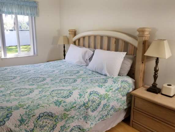 Rest easy in your cozy bedroom, where soft linens and a welcoming bed invite peaceful nights. Warm natural light and thoughtful touches make this your perfect retreat after a day of adventure.