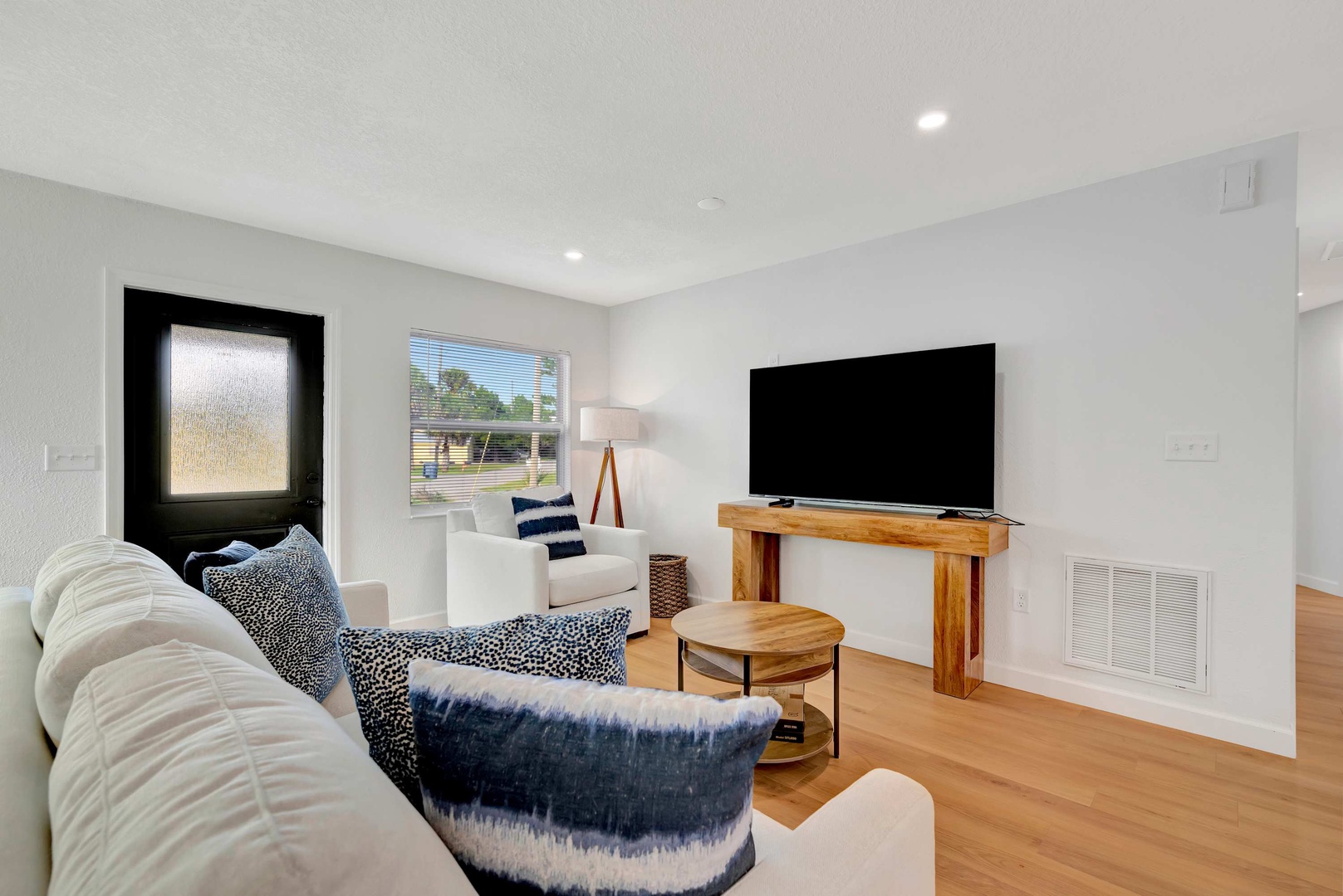 Sink into plush seating and unwind in your bright, modern living space—perfect for movie nights or morning coffee as natural light streams through the windows.