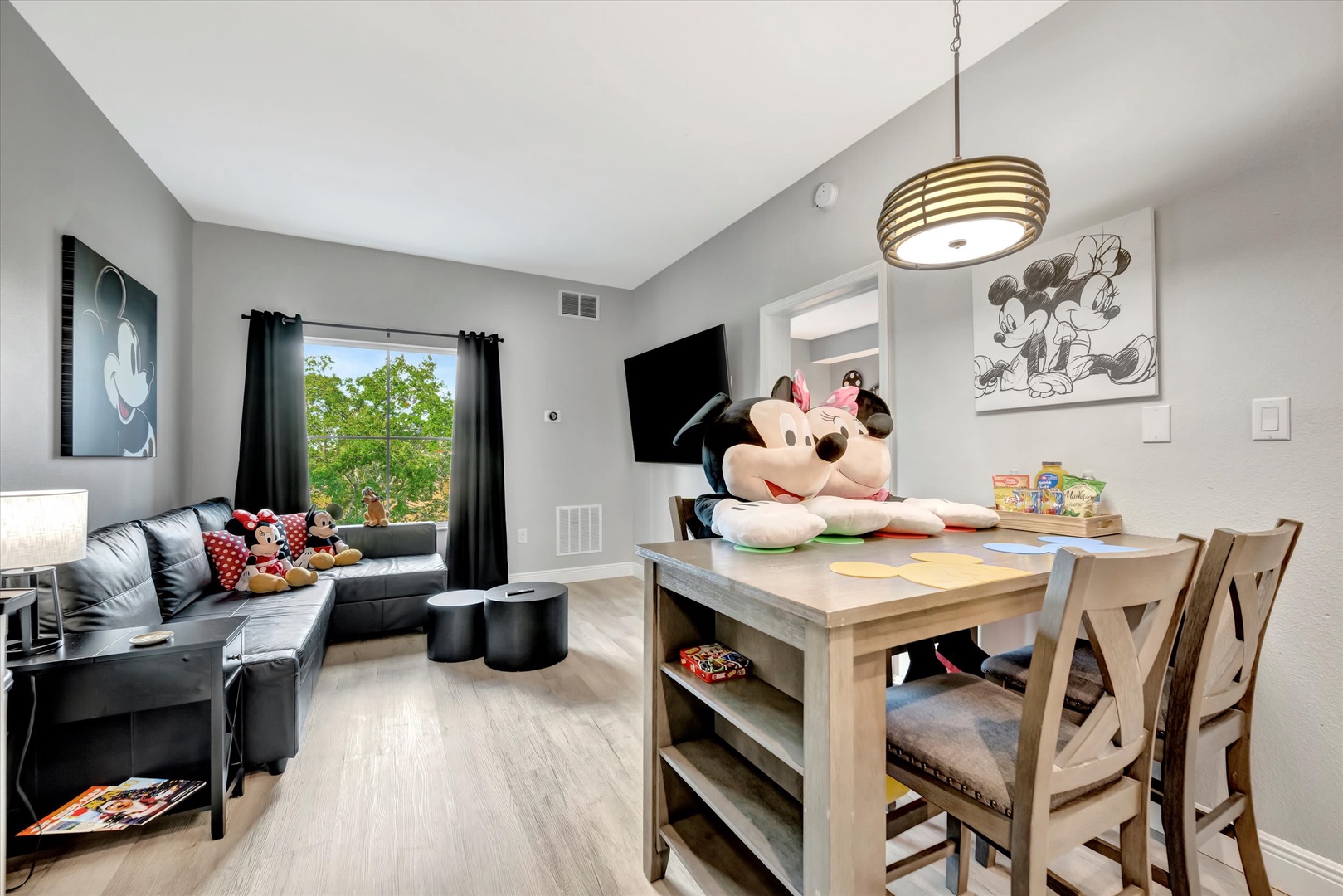 Step into your family-themed retreat, where favorite characters greet you in a bright, open space perfect for movie nights, games, and making vacation memories together.