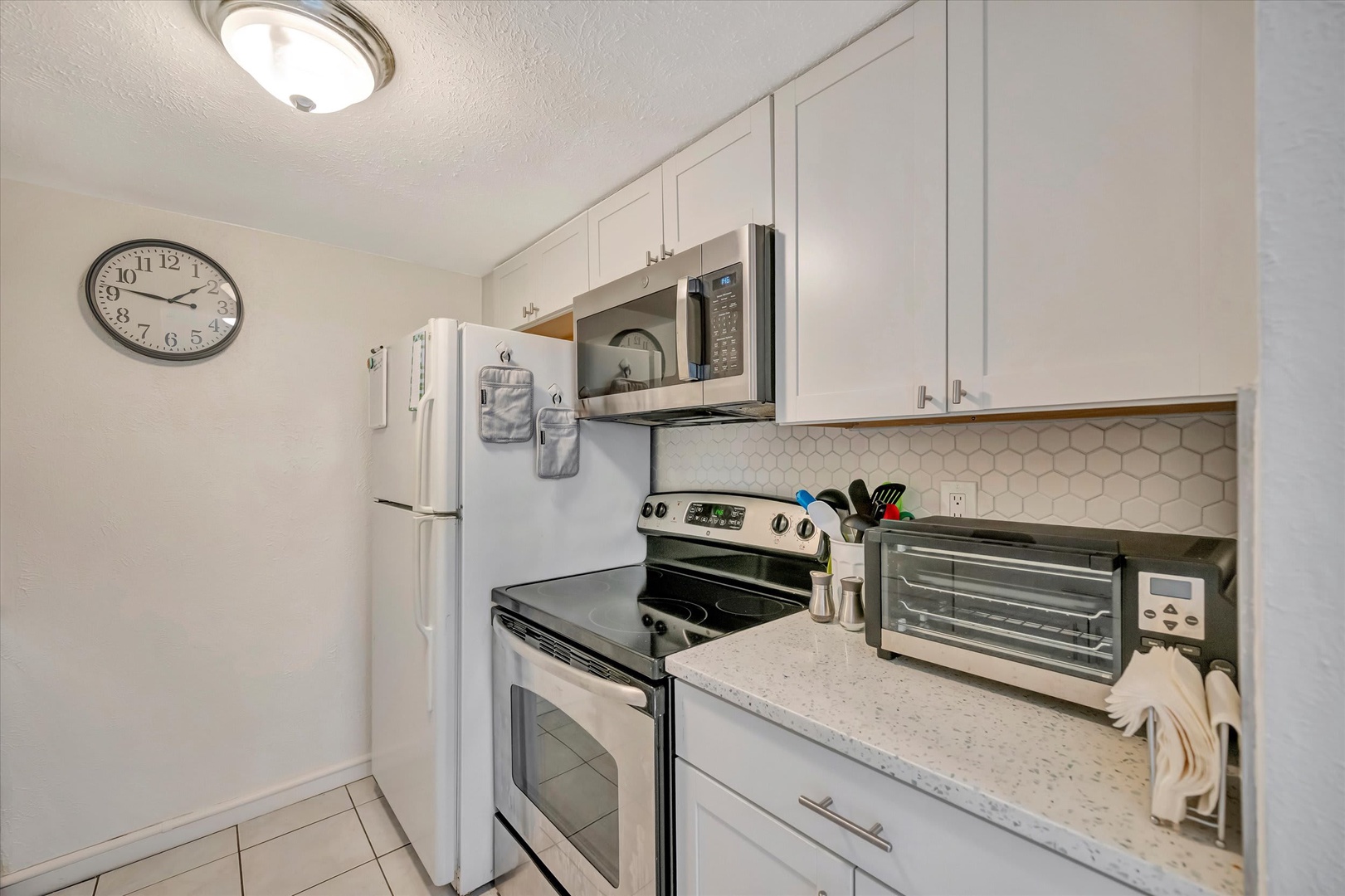 Step into your fully equipped kitchen with modern appliances, bright white cabinetry, and sleek countertops—everything you need to whip up your favorite meals during your stay.