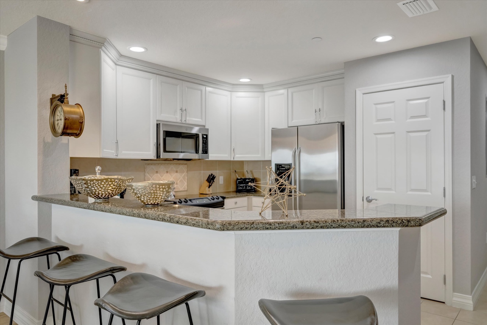 Gather around this inviting kitchen where you'll find everything you need to whip up your favorite meals. Gleaming granite counters offer plenty of prep space, while stainless steel appliances make cooking a breeze during your stay.