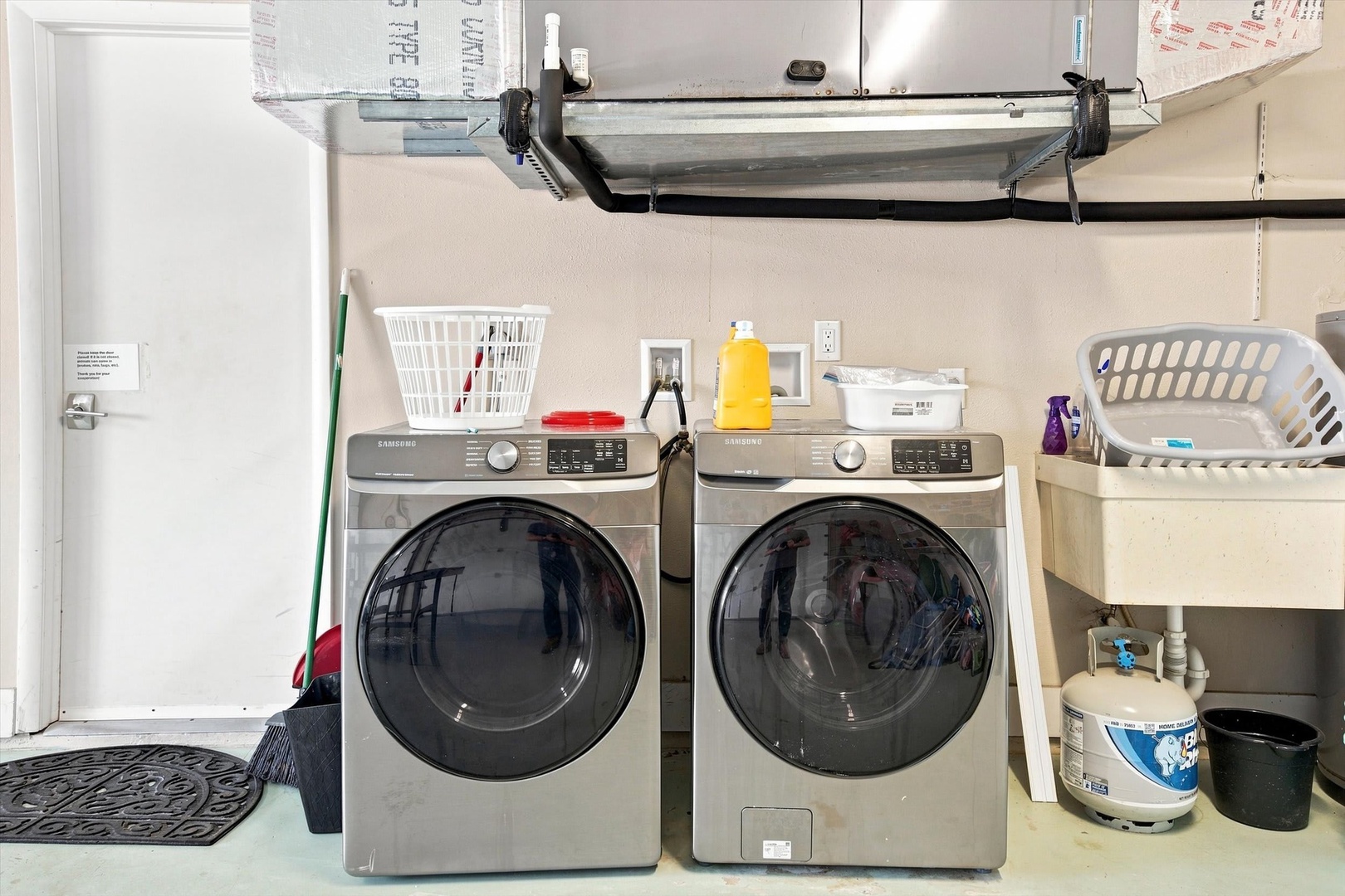 A dedicated laundry area with full-size washer and dryer makes longer stays effortless, with plenty of workspace for sorting and folding.