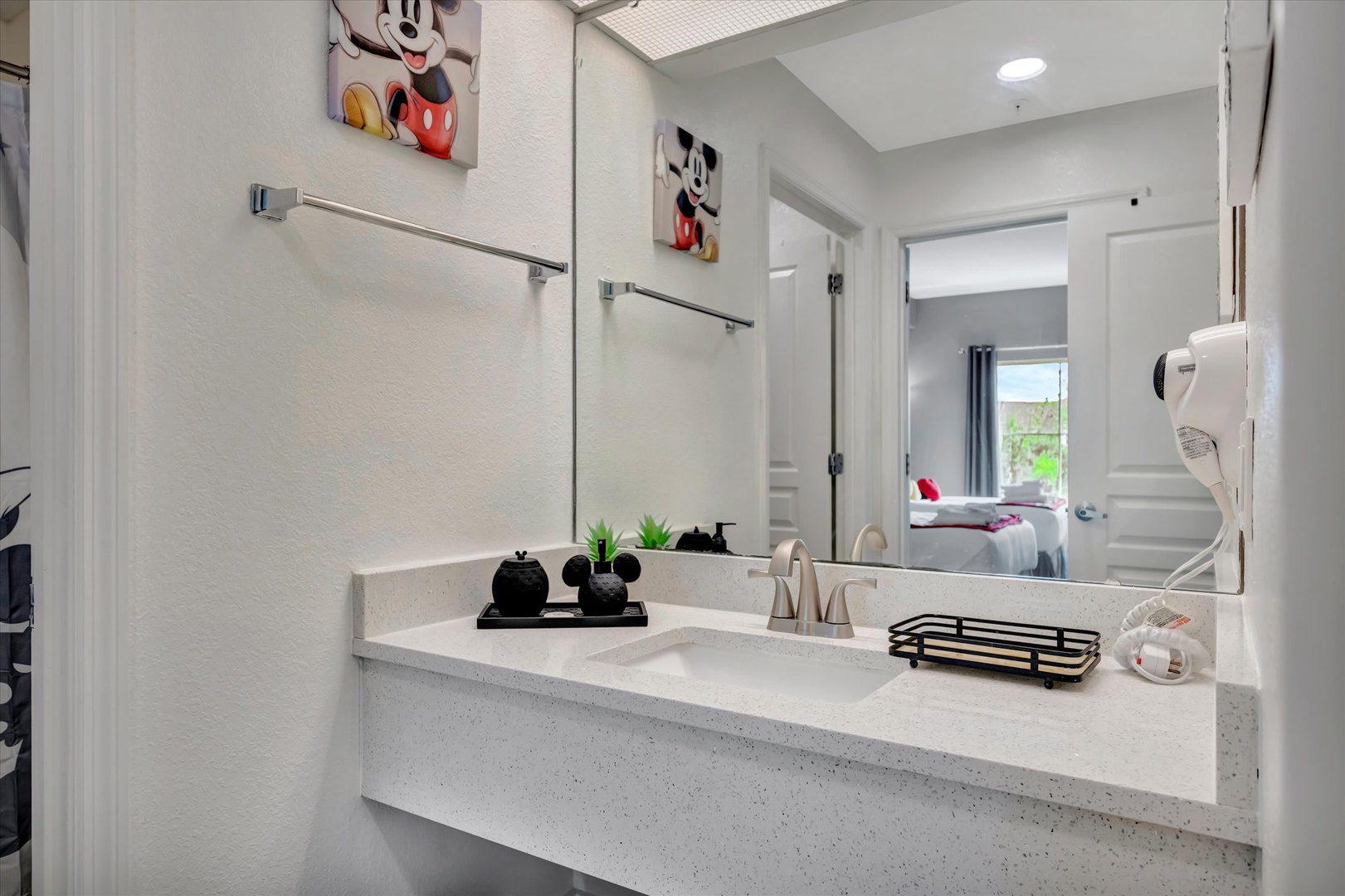 Freshen up in your sleek bathroom with modern finishes, plenty of counter space, and a convenient wall-mounted hair dryer. Playful touches bring a smile while you get ready for your next adventure.