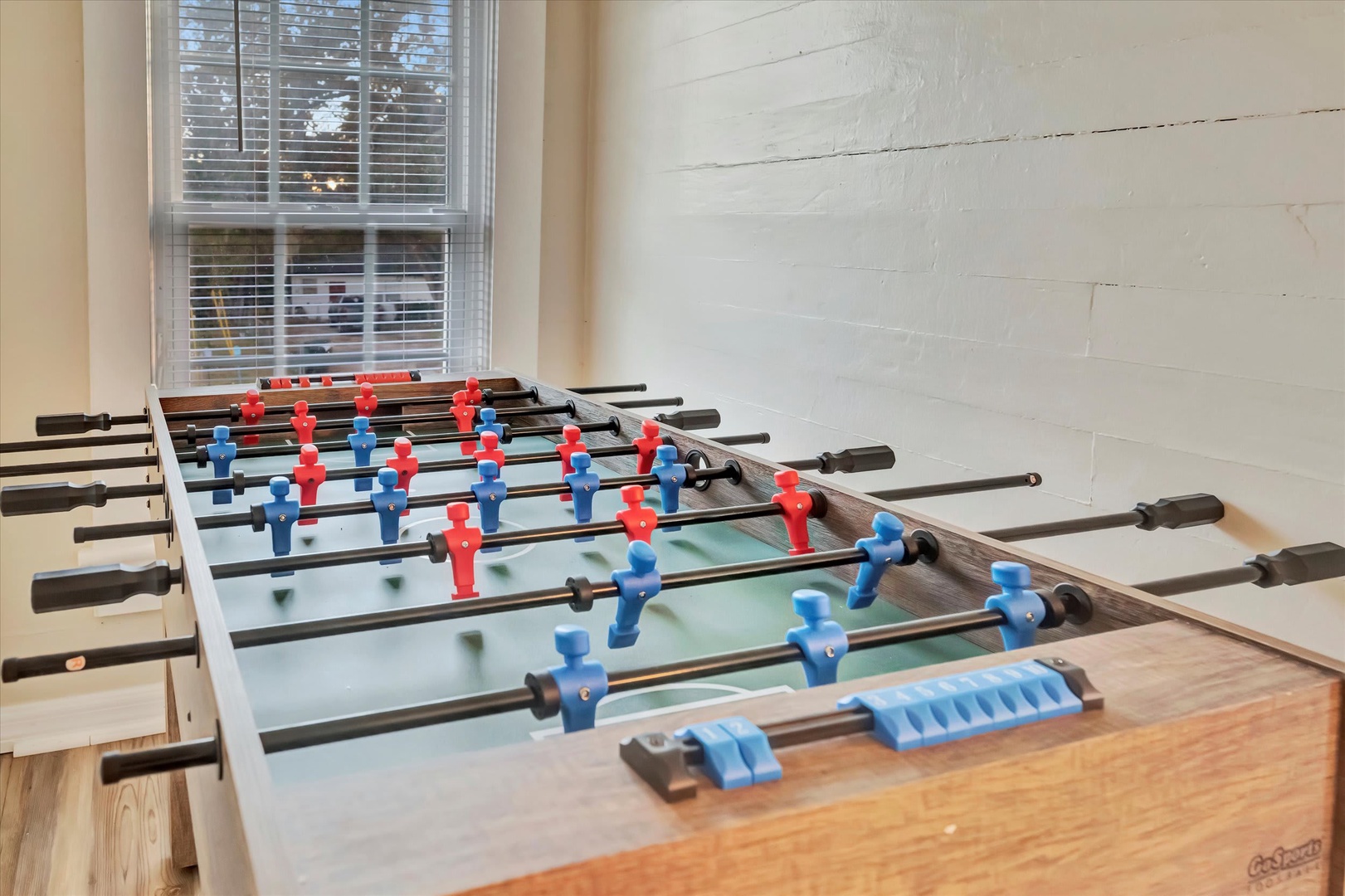Challenge your group to a friendly foosball match in the game room, where spirited competition and laughter fill the bright, welcoming space.