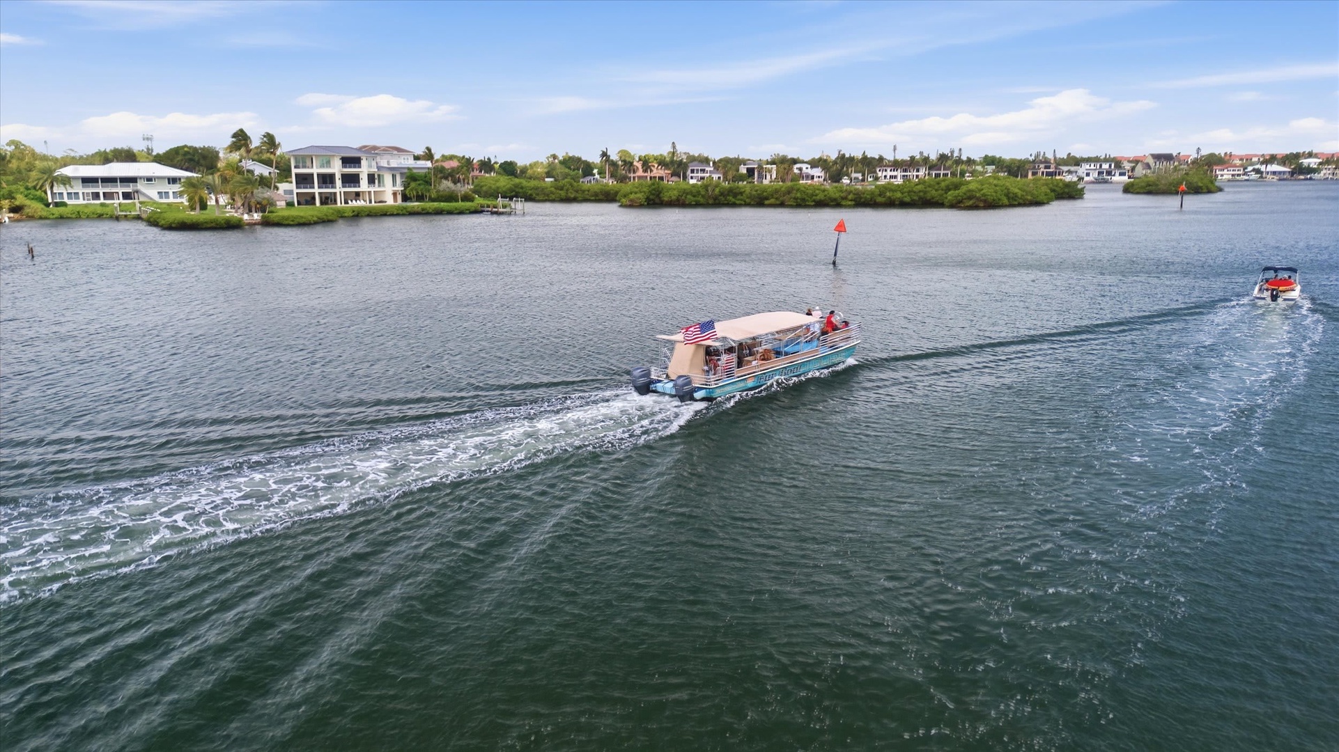 The waterfront area surrounds your property, with canal-side living creating a peaceful and scenic backdrop. Boats glide past regularly, offering a glimpse of coastal life. Nearby homes and lush greenery line the shores, making this a serene escape.