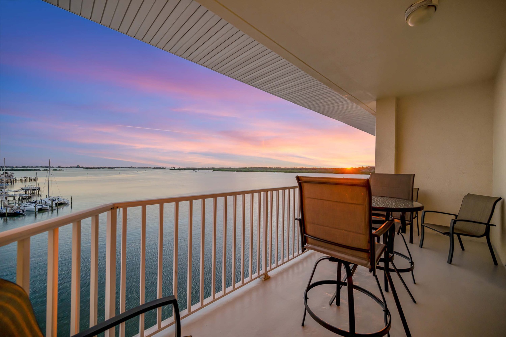 Sip morning coffee as the sun rises over calm waters, painting the sky in soft pinks and golds. Your private waterfront balcony offers front-row seats to this daily show with comfortable seating for peaceful reflection.