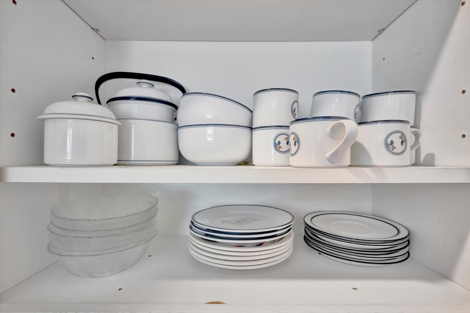Your own curated collection of dishes, bowls, and mugs await—ready for morning coffee or a home-cooked meal in your fully-equipped kitchen.