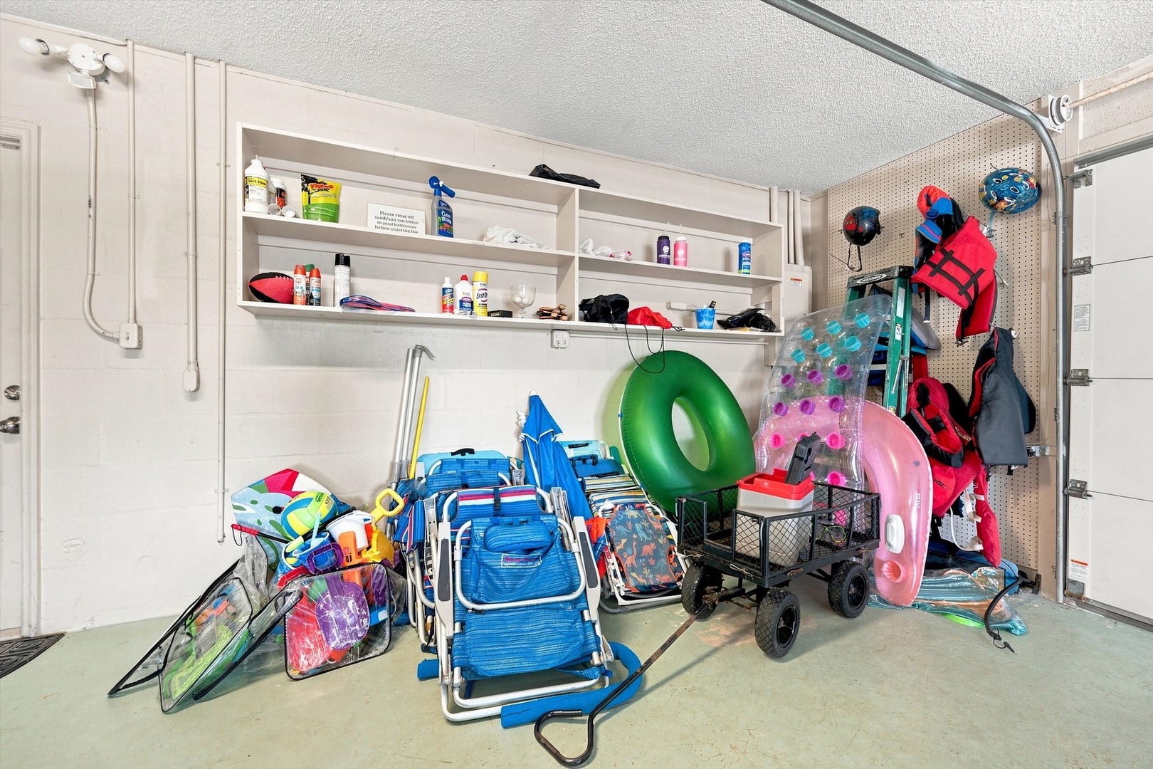 This well-organized garage storage area offers abundant space for all your beach gear, sporting equipment, and vacation essentials, making it easy to grab everything you need for a day of fun.