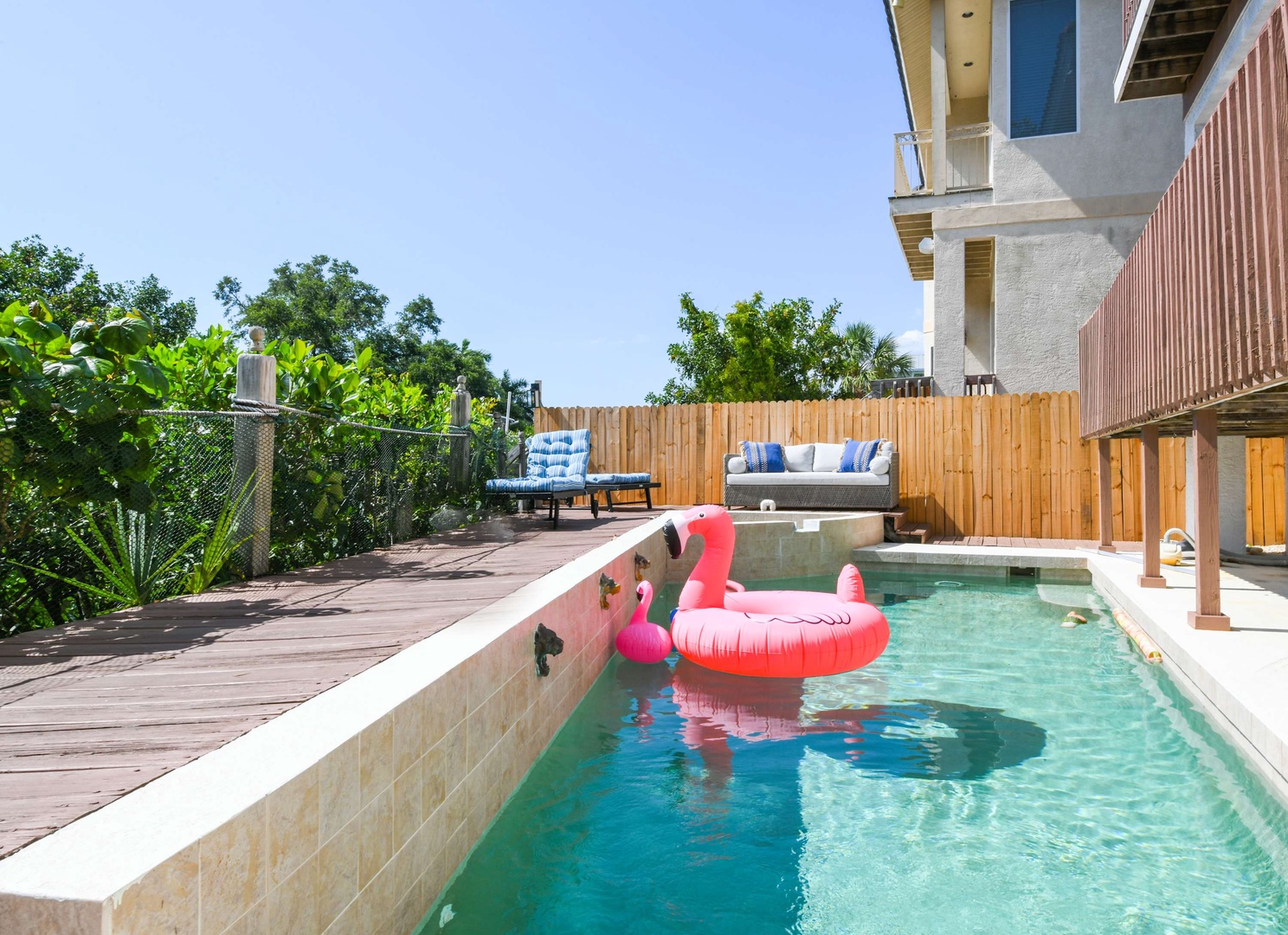 Your private outdoor oasis awaits with a sparkling pool, stylish lounge seating, and peaceful garden surroundings—perfect for soaking up the sun or floating away on a lazy afternoon.