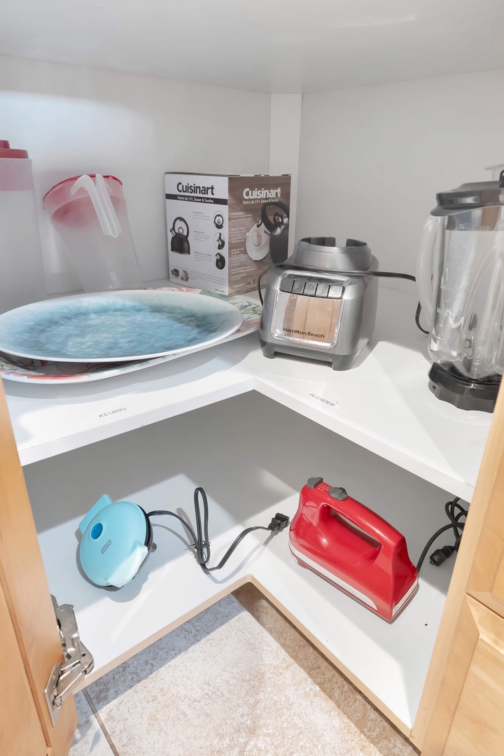 Your kitchen is fully stocked with everything you need: blenders, mixers, colorful dishware, and a well-organized pantry make cooking here feel effortless and fun.