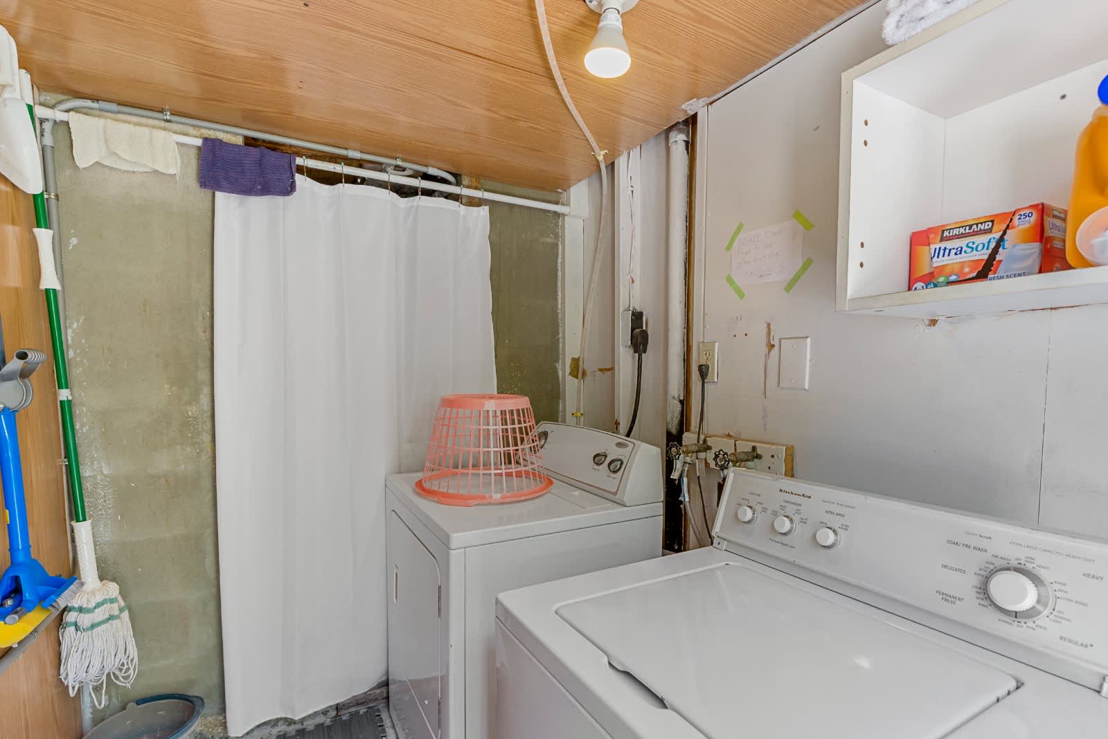 Your laundry room is ready for use with a full-size washer and dryer, plus shelving to keep everything organized and at your fingertips.