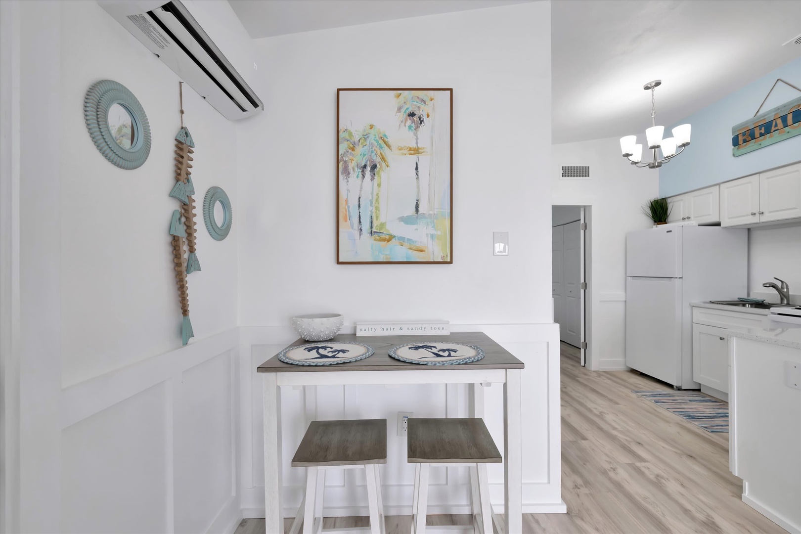 Gather for a relaxed meal at your cozy dining nook, where coastal decor and an open layout make every moment feel effortlessly breezy and inviting.