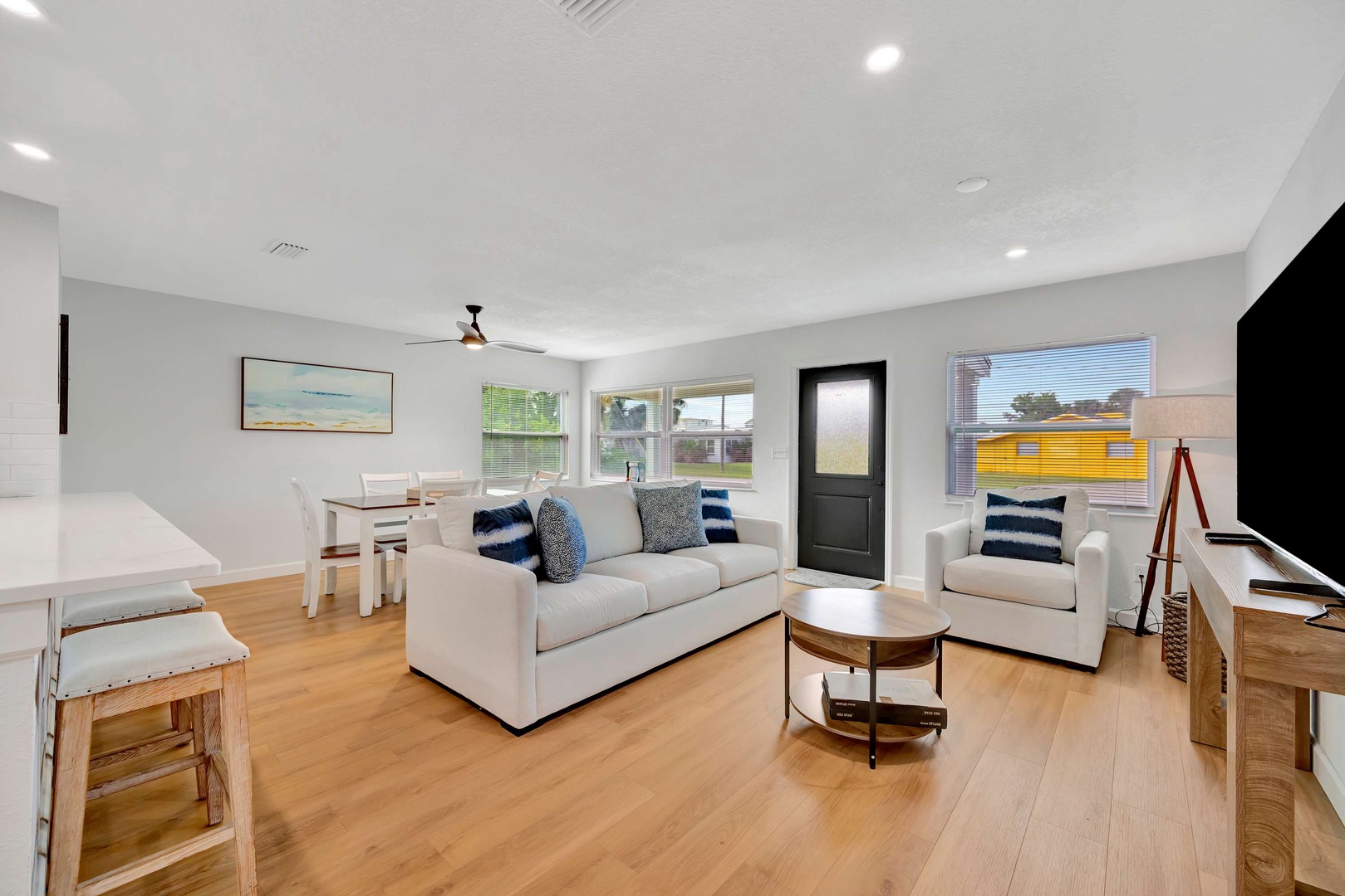Bright and welcoming open-plan living space with comfortable seating, hardwood floors, and natural light. Your dining area sits just steps from the cozy lounge—perfect for relaxing after a day exploring.