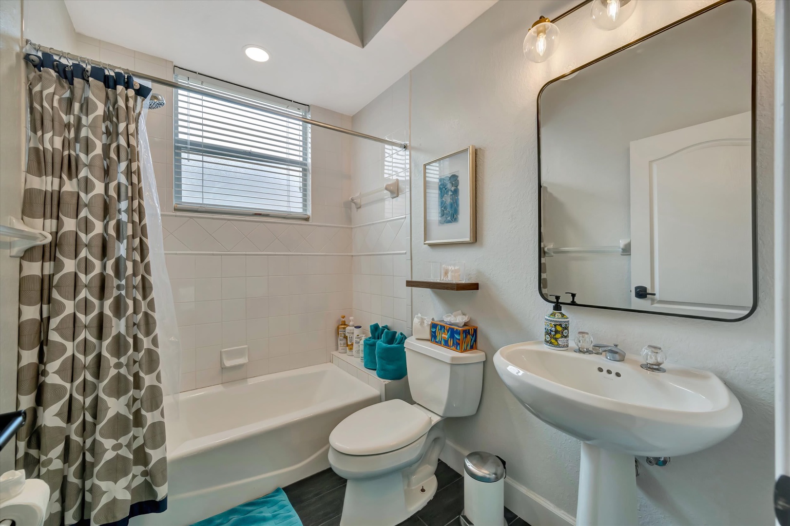 Your private bathroom features a sleek design with modern fixtures, a spacious tub-shower combo, and charming accent details to make your morning routine feel just a little more special.