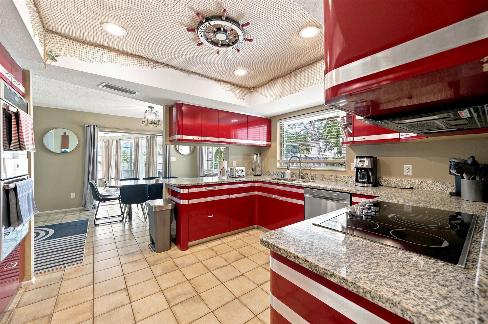 Step into your bright, fully equipped kitchen with sleek granite counters, modern appliances, and a charming nautical ceiling detail—perfect for whipping up family meals or morning coffee before exploring the coast.