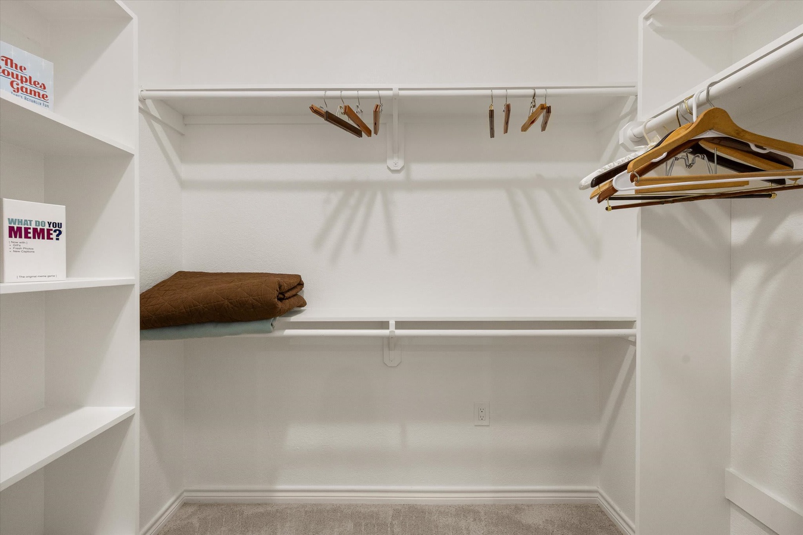 A spacious walk-in closet gives you plenty of room to organize your wardrobe with ample hanging space, shelving, and folded storage.