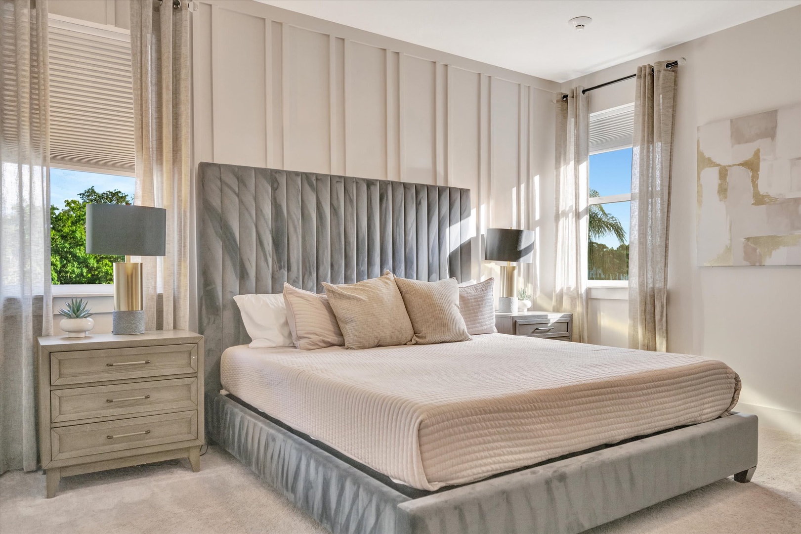 Drift off into peaceful sleep in this elegant bedroom, where soft neutral tones and natural light create your serene retreat. The plush king bed invites you to unwind, while palm trees sway just beyond your window.