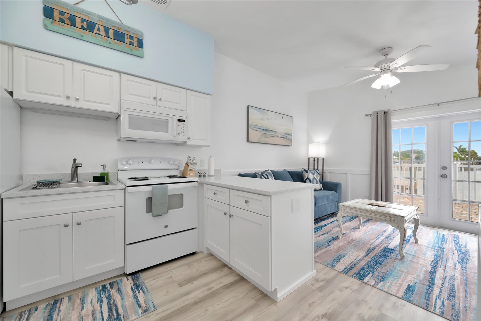 Your beach-inspired retreat greets you with coastal charm—a bright, open space where soft blues and whites create the perfect backdrop for relaxing after your adventures. Cook, lounge, and unwind all in one inviting haven.