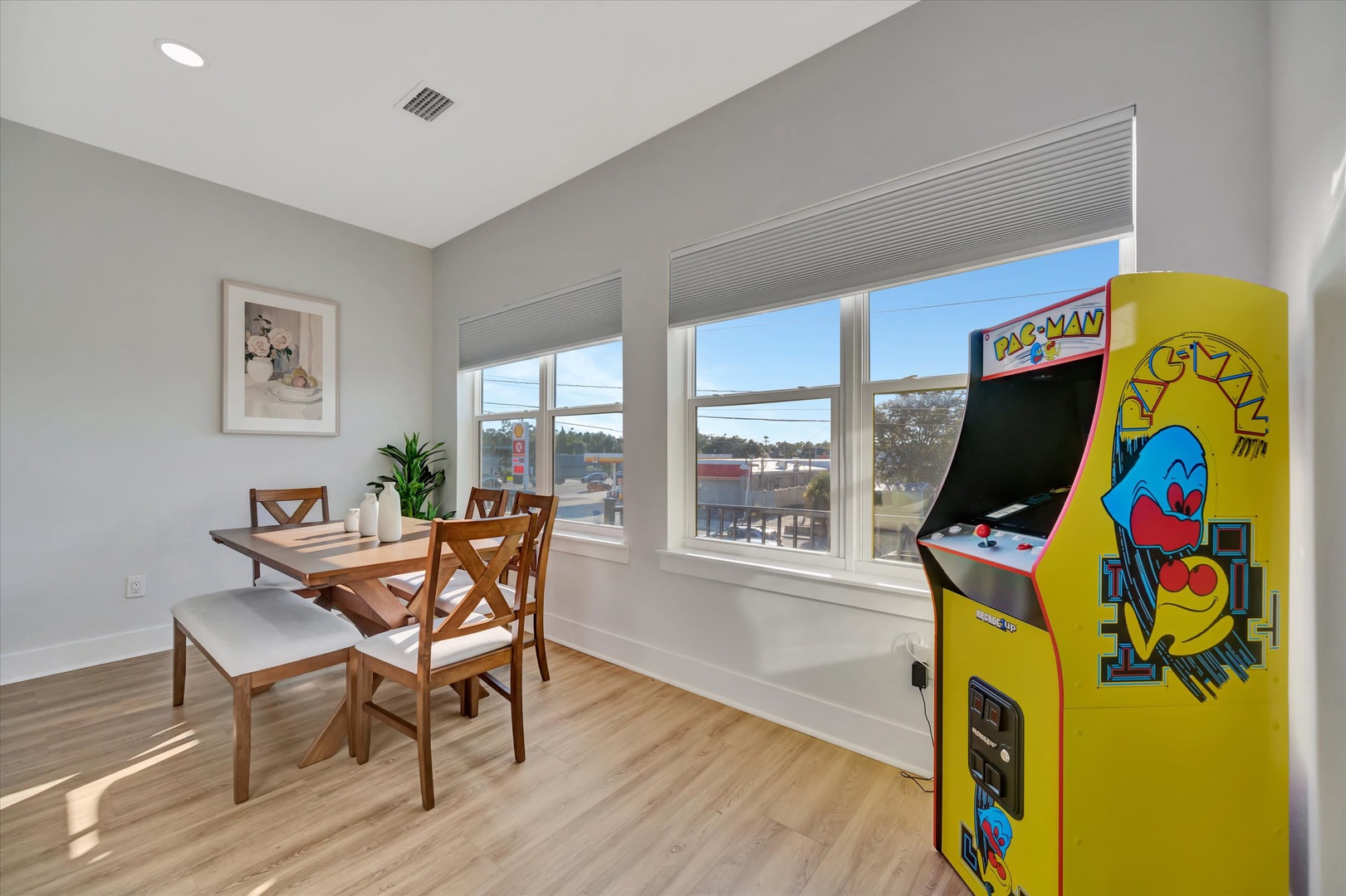 Enjoy casual meals at your dining table while natural light pours through the windows. Challenge your companions to a round on the classic Pac-Man arcade game—fun awaits anytime.
