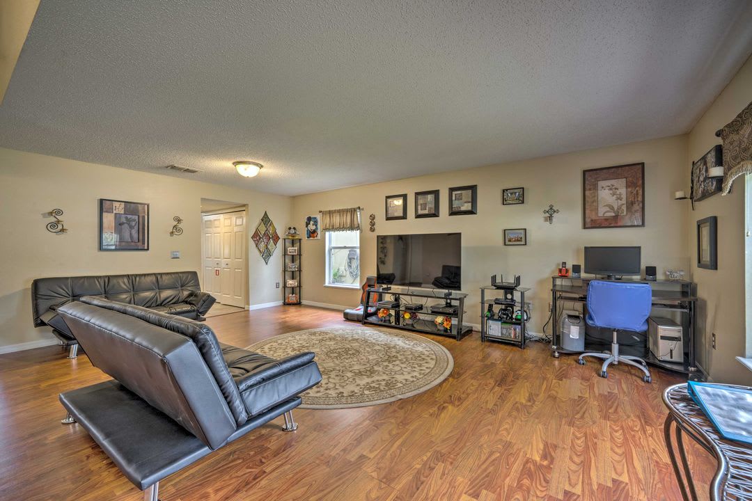 Settle into this open living space where modern style meets comfort. Gleaming wood-style floors and sleek seating create a perfect spot to unwind after exploring the area.