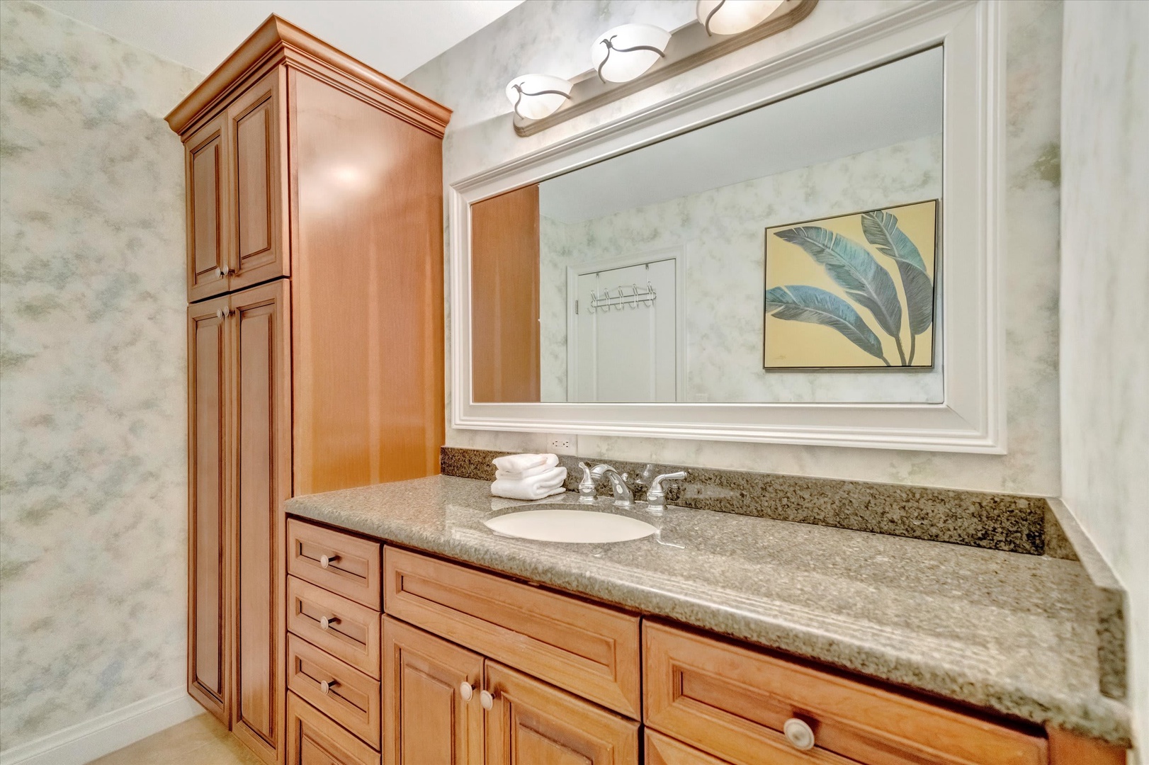Freshen up at your spacious granite vanity, complete with custom cabinetry and thoughtful lighting. Plush towels await after a long day of exploring.