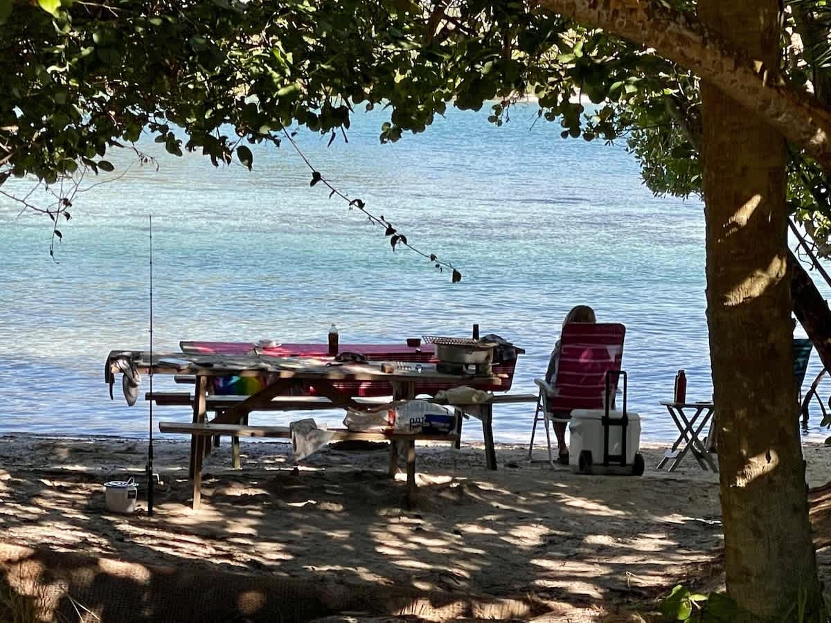 Your own private waterfront escape awaits — unwind in the shade of leafy trees, cast a line, and soak in serene lake views steps from your chair.