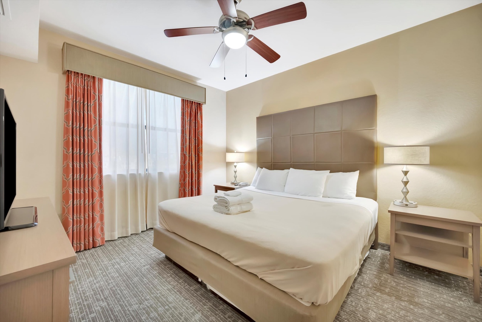 Sink into crisp linens and plush bedding in your welcoming bedroom retreat. Soft lighting and a ceiling fan ensure your comfort after a day of exploring.