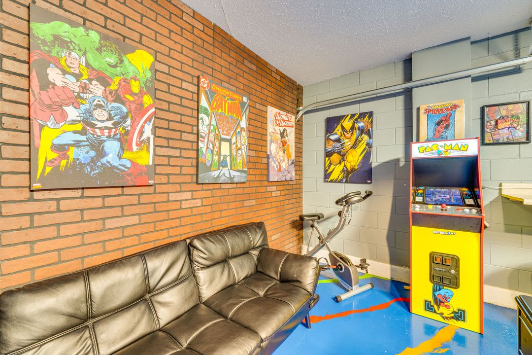 Unwind in your own game room, complete with vintage arcade fun, comfortable seating, and bold comic-style décor that brings superhero energy to every moment.
