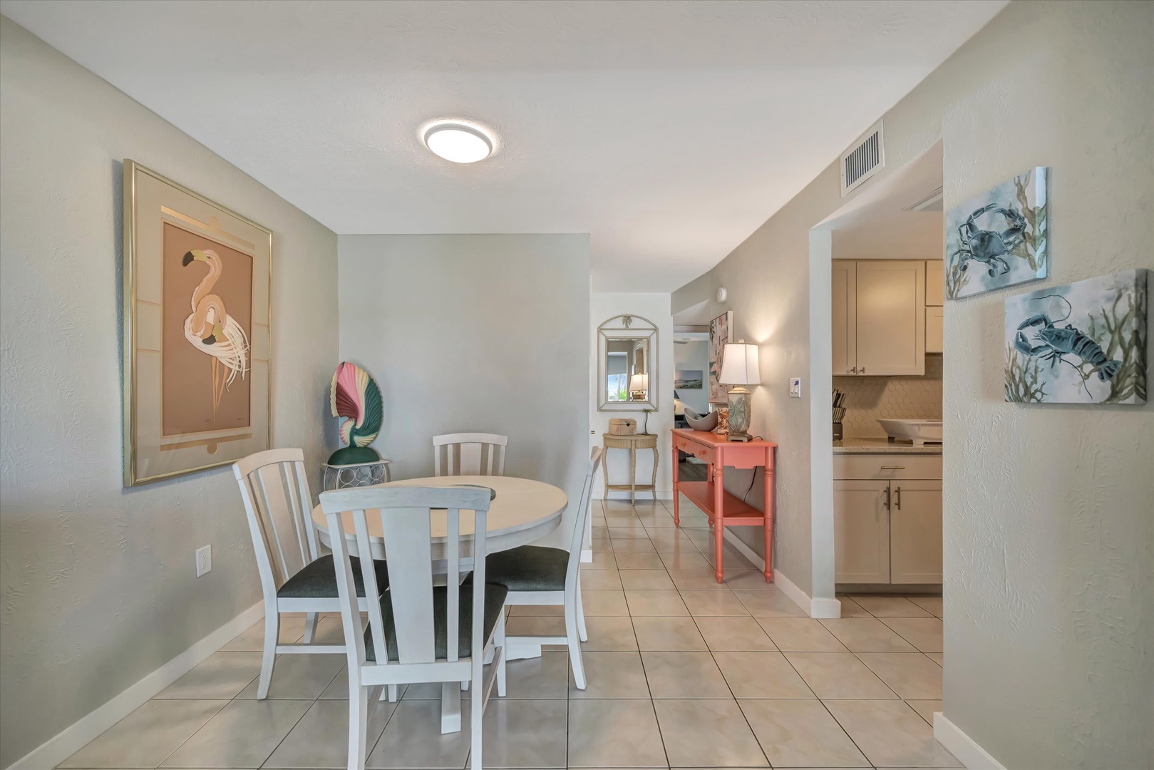 Step inside this charming coastal-themed space where your morning coffee tastes even better. Coastal artwork adds seaside charm, while the open layout flows effortlessly from dining to kitchen—perfect for easy meal prep and relaxed gatherings.
