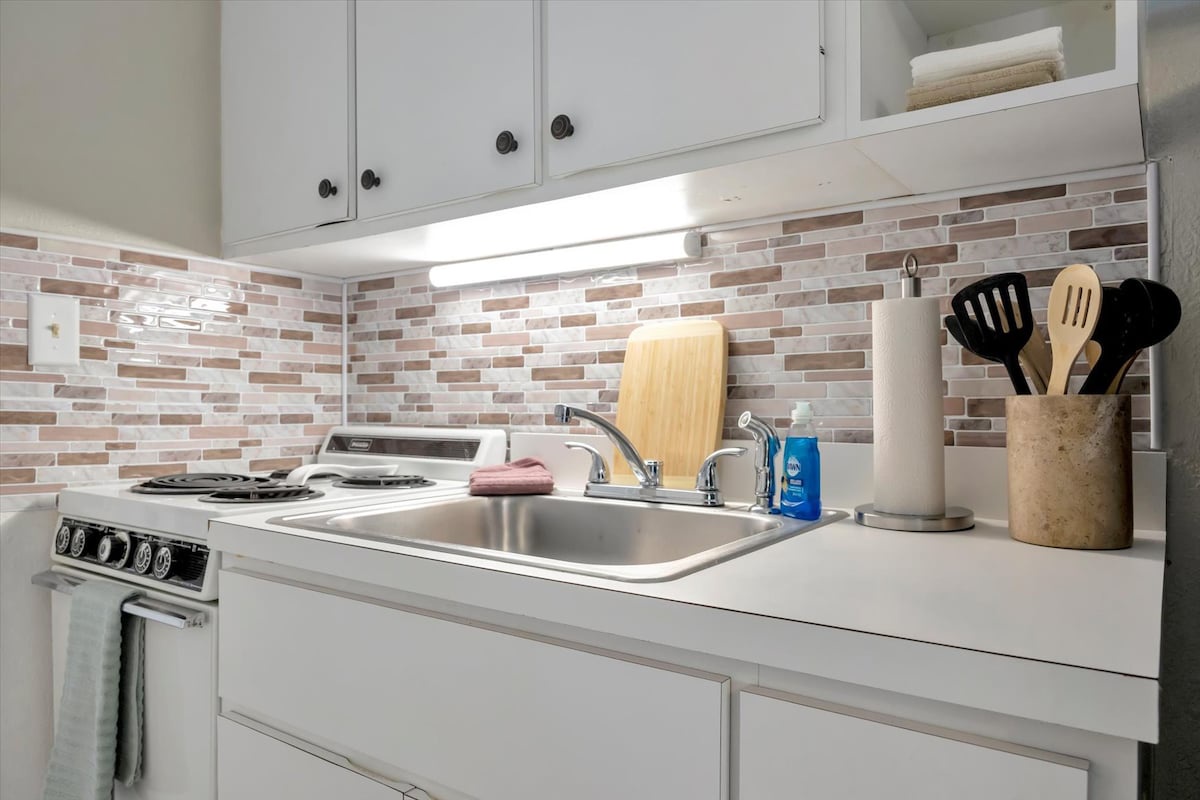 Your fully equipped kitchen awaits with everything you need to prepare meals at your own pace. Modern appliances, bright lighting, and a charming backsplash make cooking feel effortless and enjoyable.