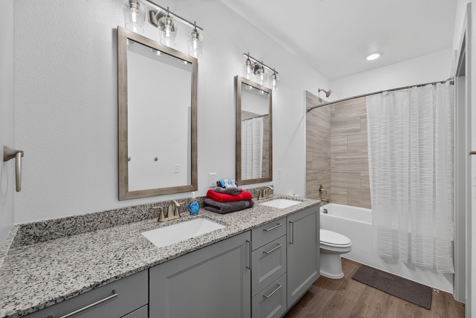Freshen up in your stylish bathroom with dual vanities, granite countertops, and elegant finishes. Luxuriate in the tub-shower combo after a day of exploring.