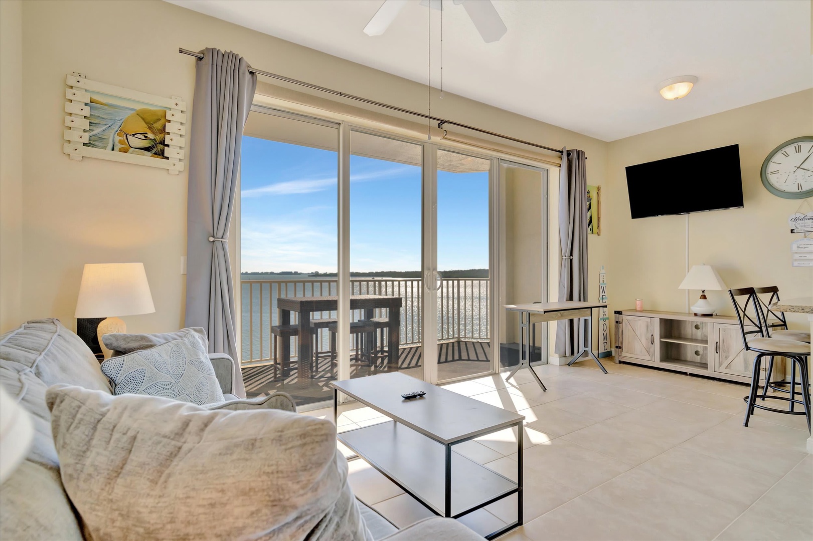 Settle into your bright living space where natural light pours through sliding glass doors. Step out to your private balcony and savor the open landscape unfolding before you—a perfect spot to unwind with your morning coffee.