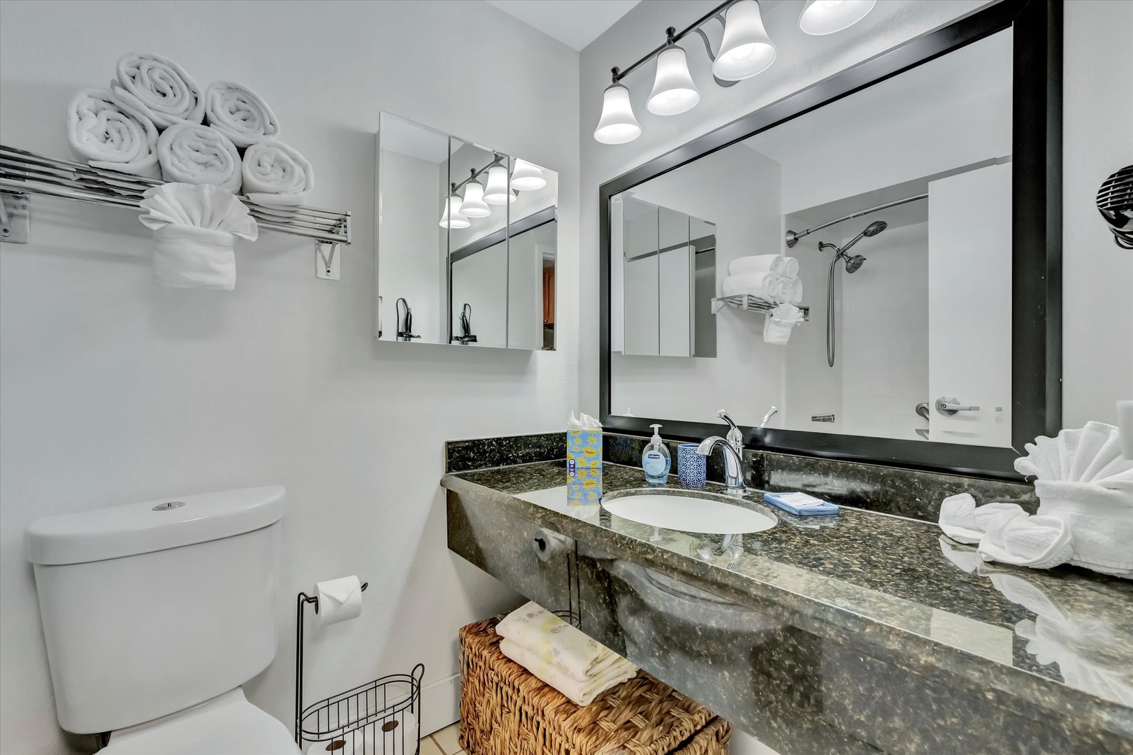 Freshen up in your modern bathroom, thoughtfully outfitted with granite counters, bright lighting, and fluffy towels to make every morning feel like a fresh start.