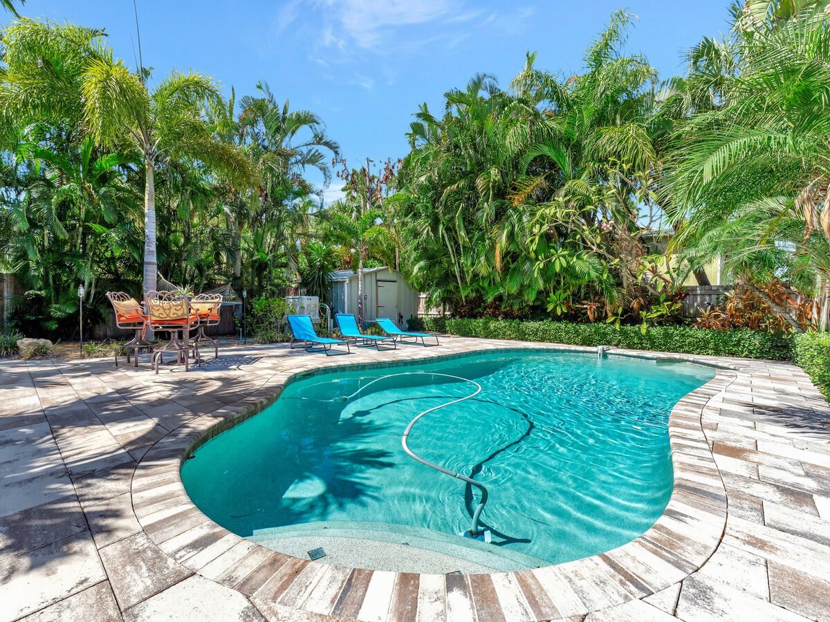 A private tropical oasis set among swaying palms and lush greenery. Bright lounge chairs and a spacious patio create the perfect setting for lazy afternoons under the sun.
