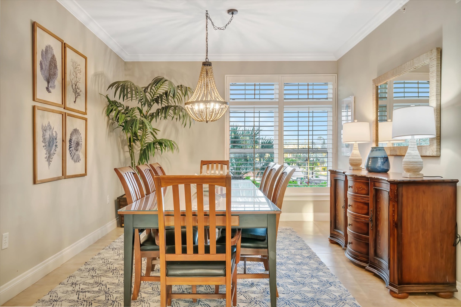 Gather around this inviting dining space where natural light and coastal charm create the perfect setting for your morning coffee or evening meals together.